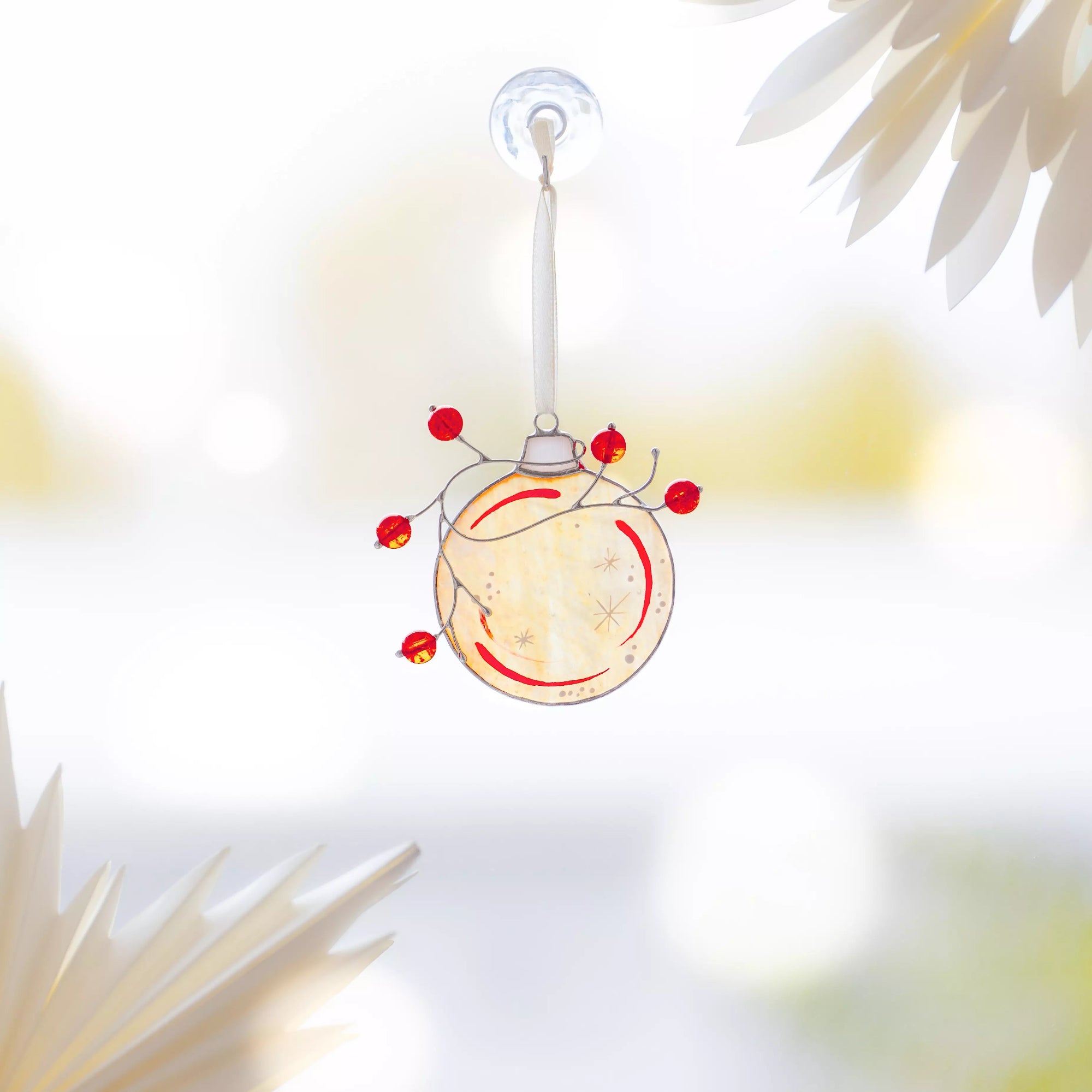 Stained glass holiday ball with red beads, elegant Christmas decoration for windows