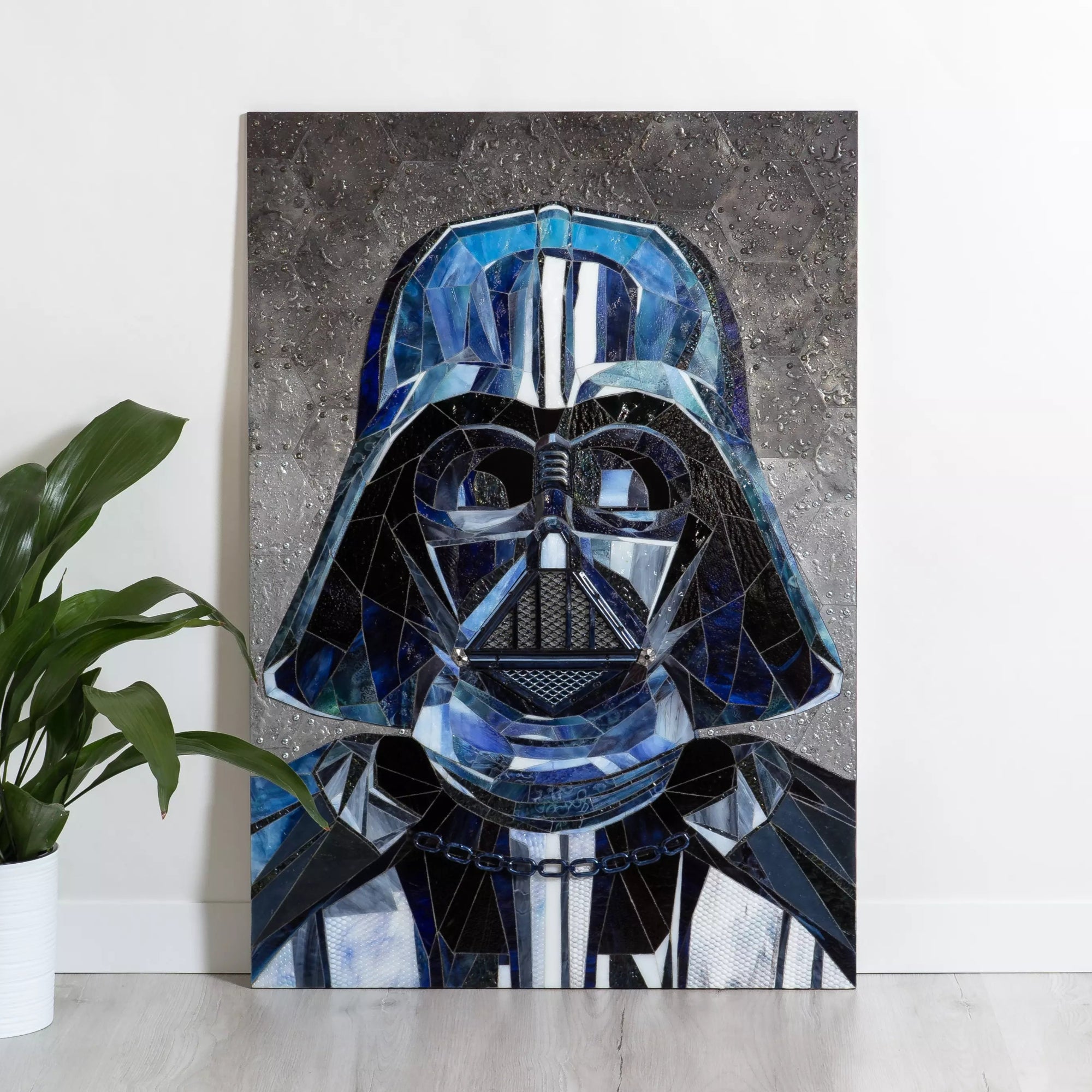 Interior view with stained glass Darth Vader mosaic beside a plant for size reference.
