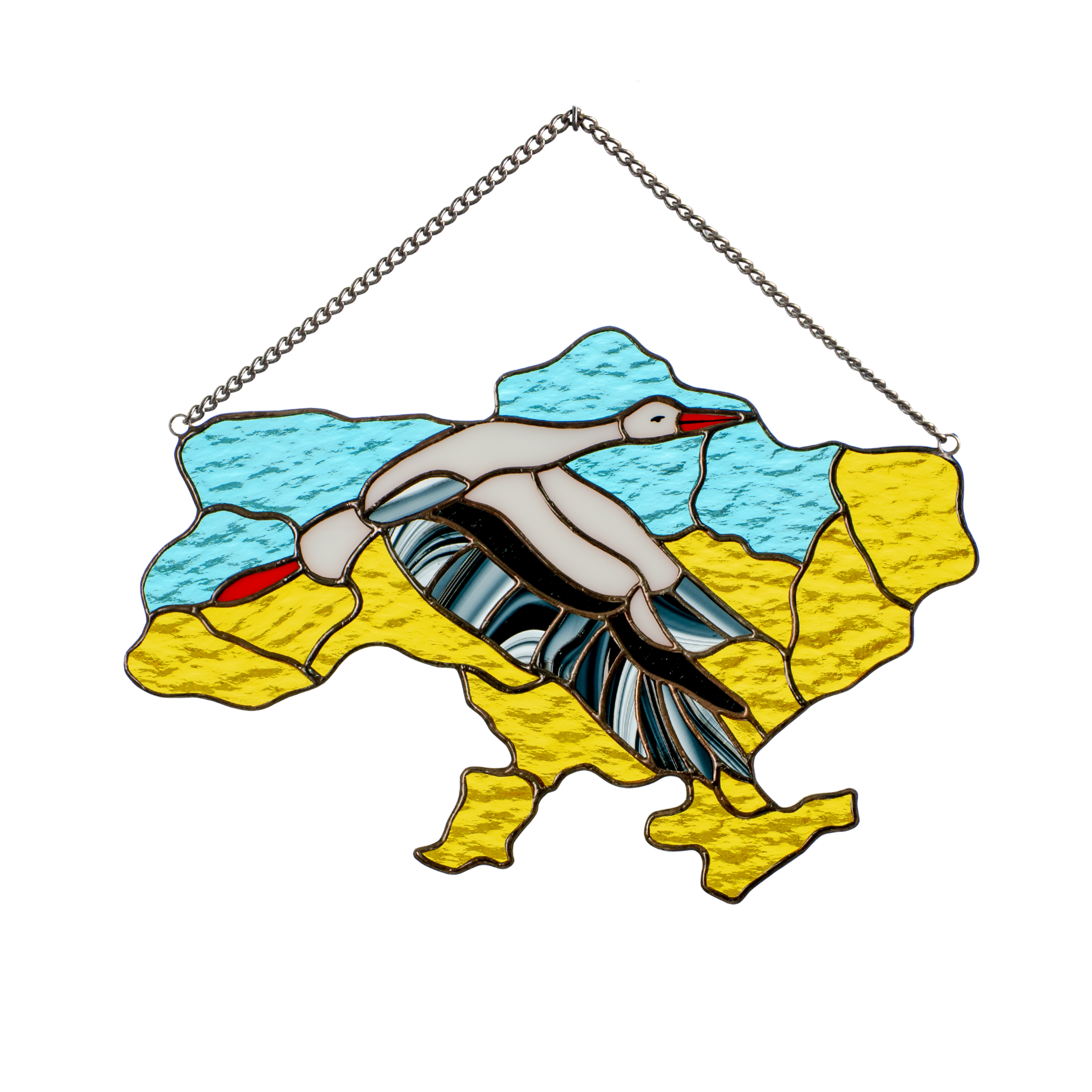 Stained glass piece shaped like Ukraine with blue and yellow background and a flying stork across the center.