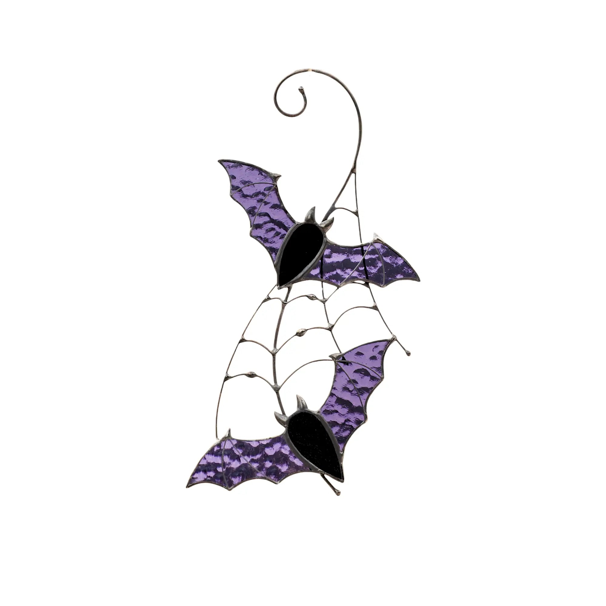 Two stained glass bats with purple wings on spiderweb frame hanging ornament