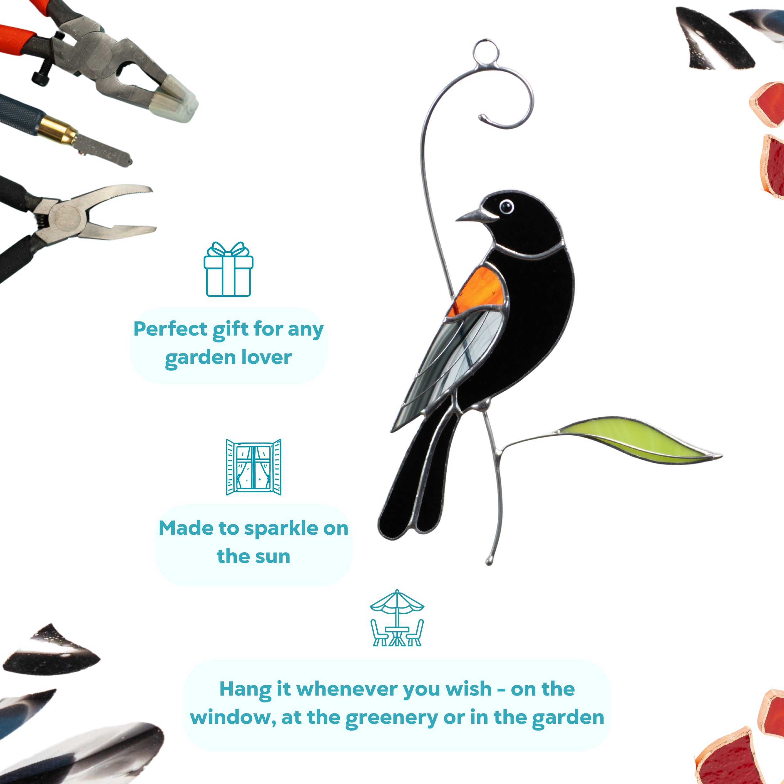 Stained glass blackbird hanging with orange wing, perched above a green leaf, ideal for garden lovers.