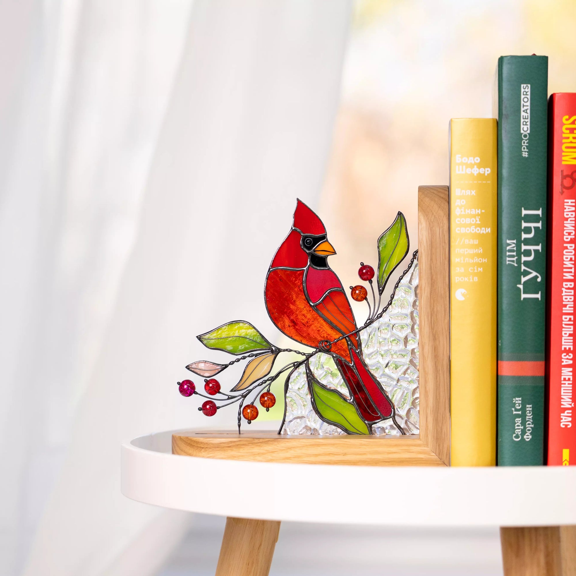 Decorative stained glass bookend panel cardinal catching natural light, perfect for bookshelf decor or nature-inspired home accents.