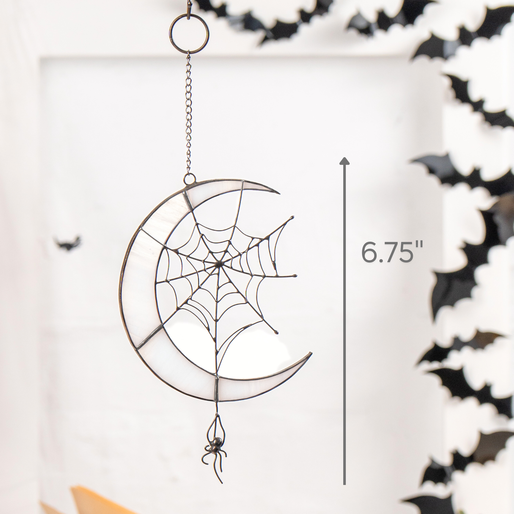 Crescent moon spider suncatcher hanging among black bat decorations with 6.75" size marked.