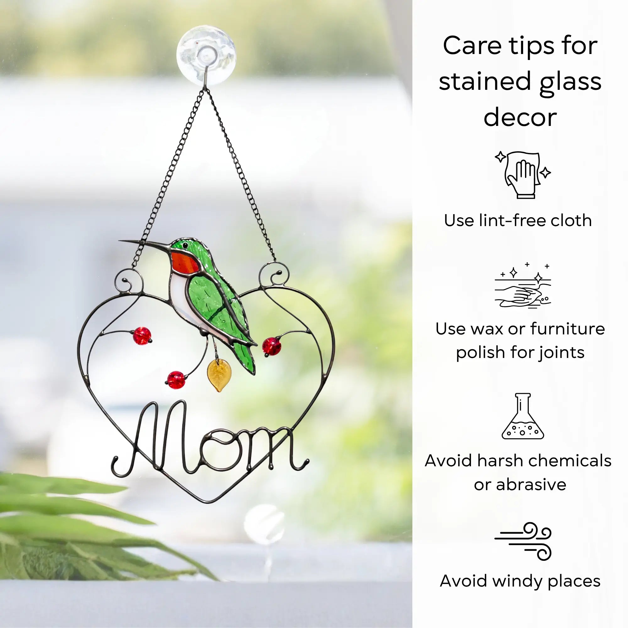 Stained glass decor with a hummingbird and 'Mom' text, featuring care tips on a blurred natural background: use lint-free cloth, polish joints with car wax or furniture polish, avoid harsh chemicals, and windy places.