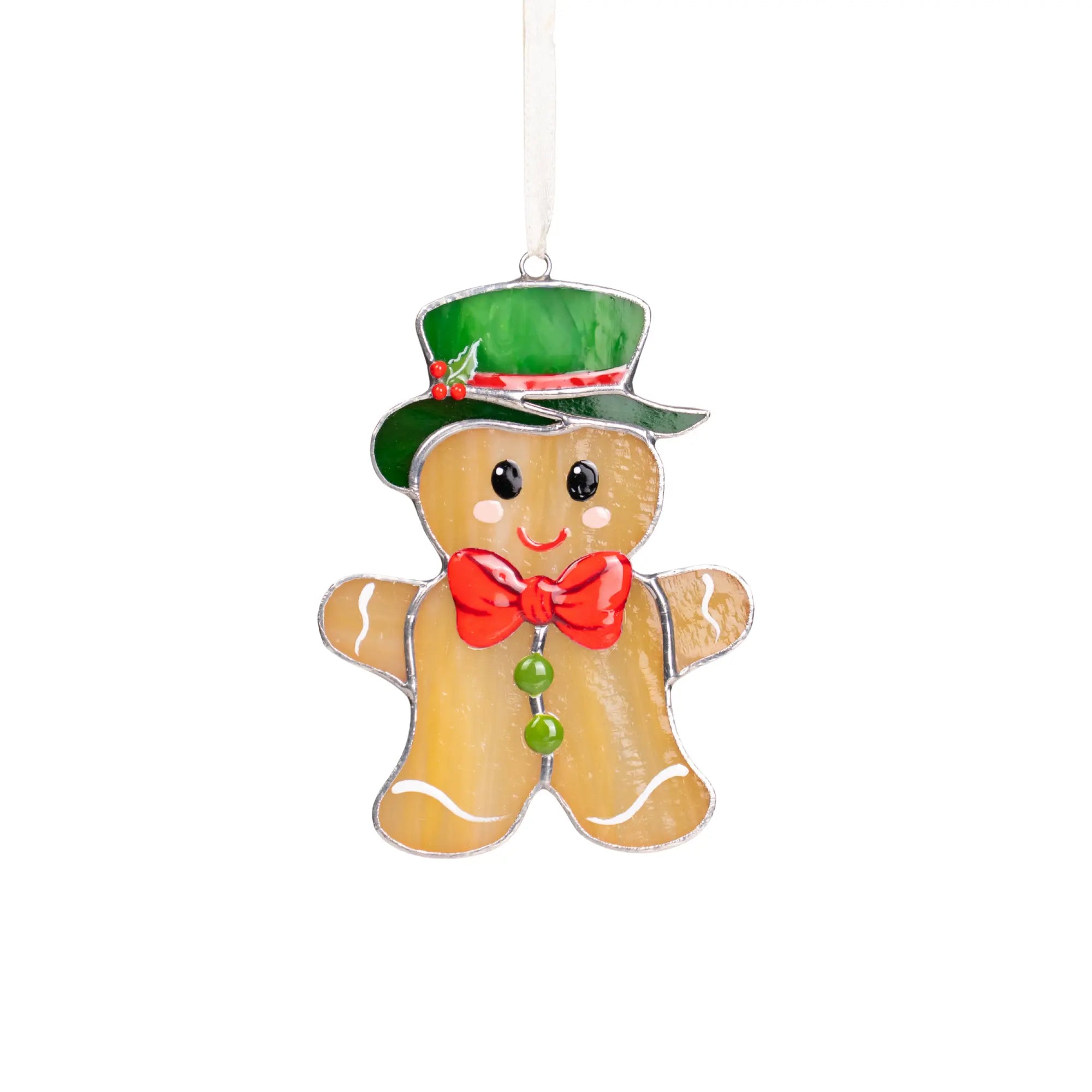 Gingerbread man stained glass suncatcher with shiny green hat, red bow tie, and holly detail on white background.