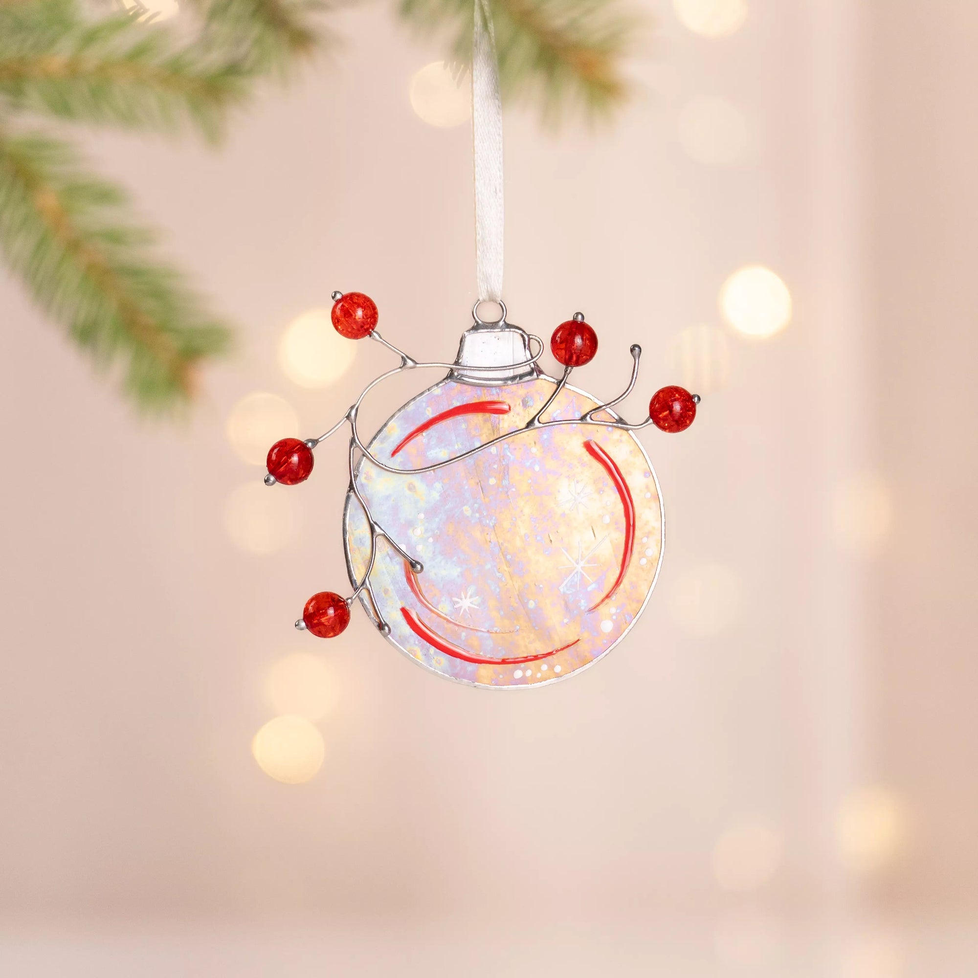 Christmas ball ornament with red beads, made of stained glass with an iridescent finish