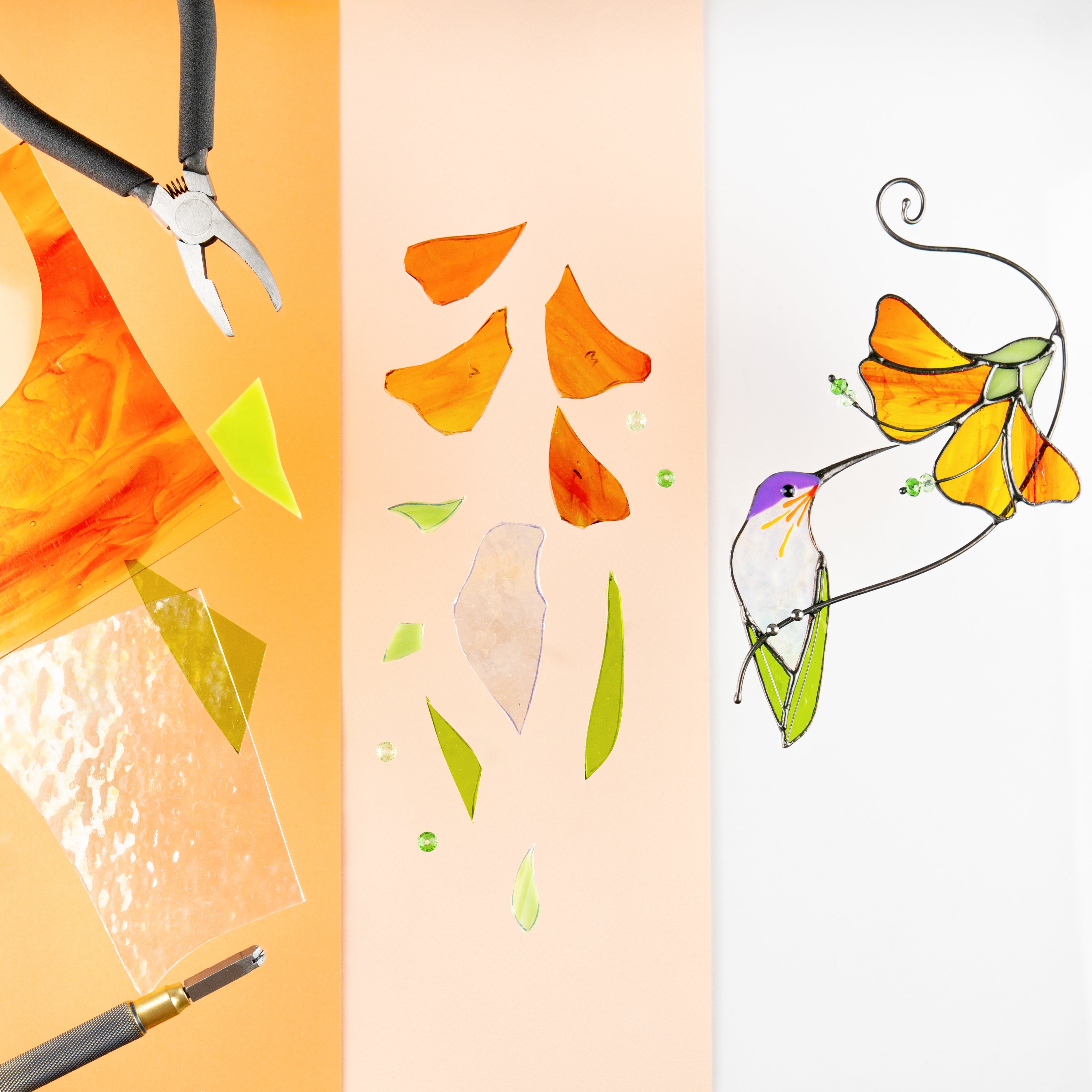 Stages of creating a stained glass hummingbird with orange hibiscus, surrounded by cut glass and pliers