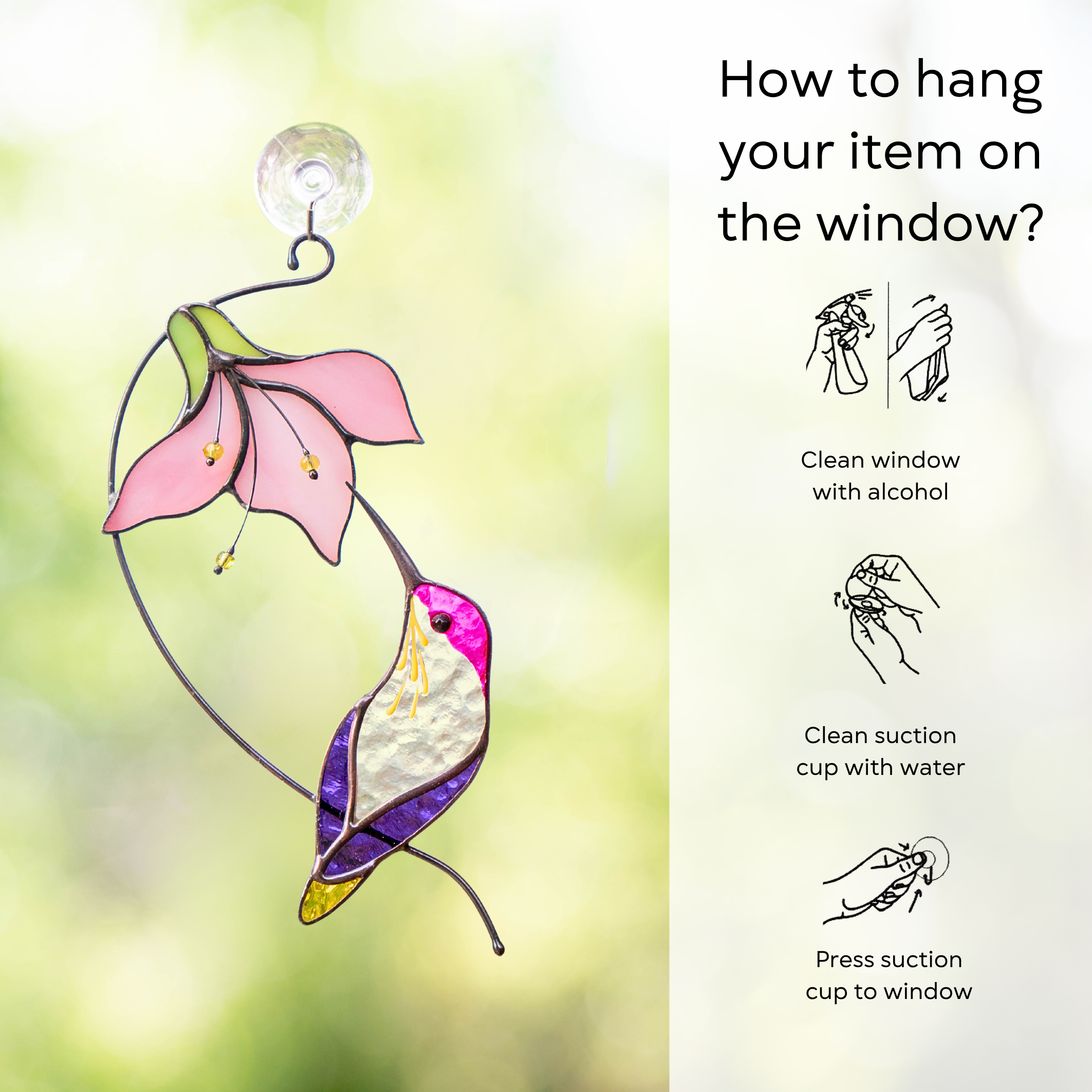 Glass hummingbird and flower suncatcher hanging from a suction cup on a window, glowing in daylight with instruction beside: use lint-free cloth, polish joints with car wax or furniture polish, avoid harsh chemicals, and windy places.