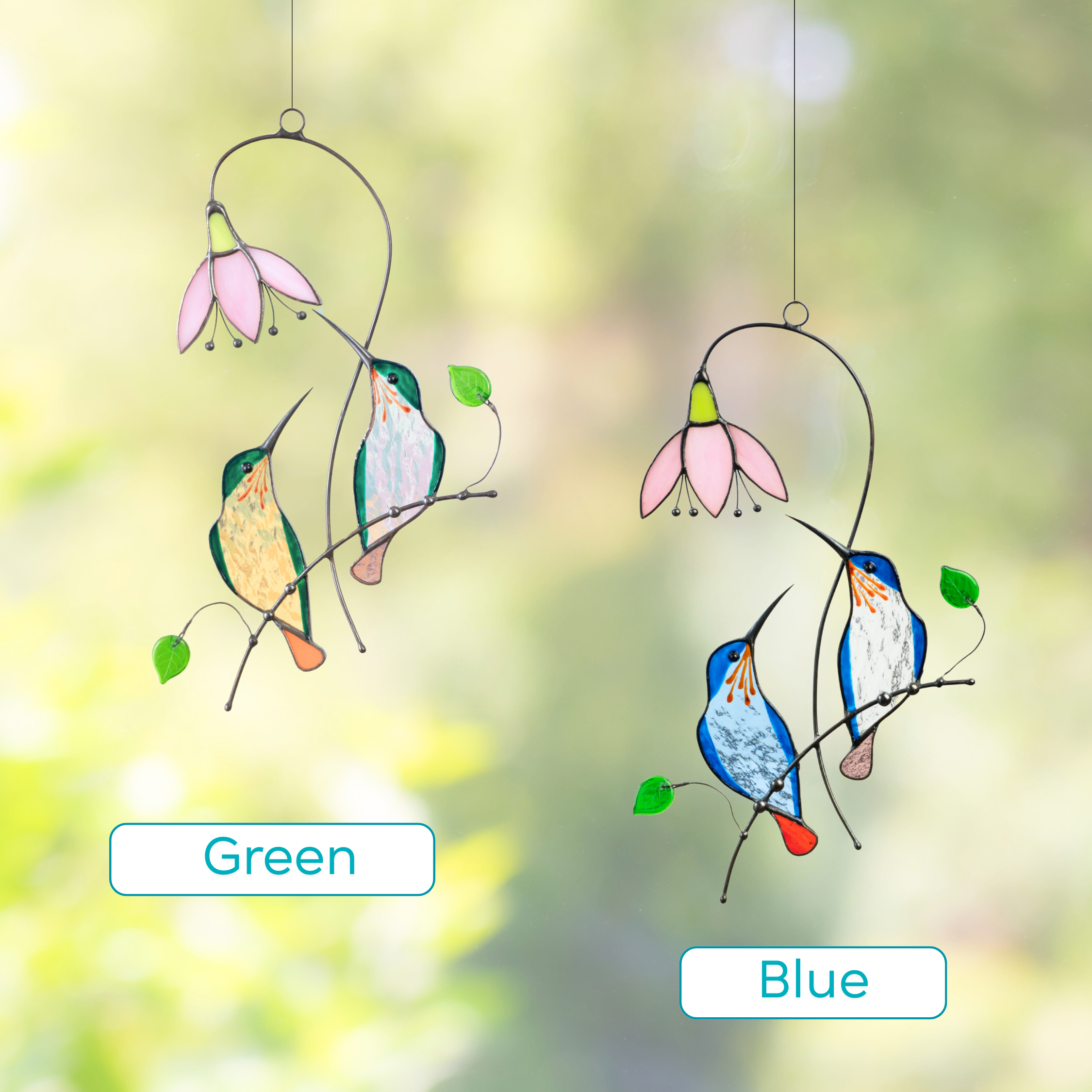 Two stained glass suncatchers featuring hummingbird pairs in green and blue, each near a pink flower.