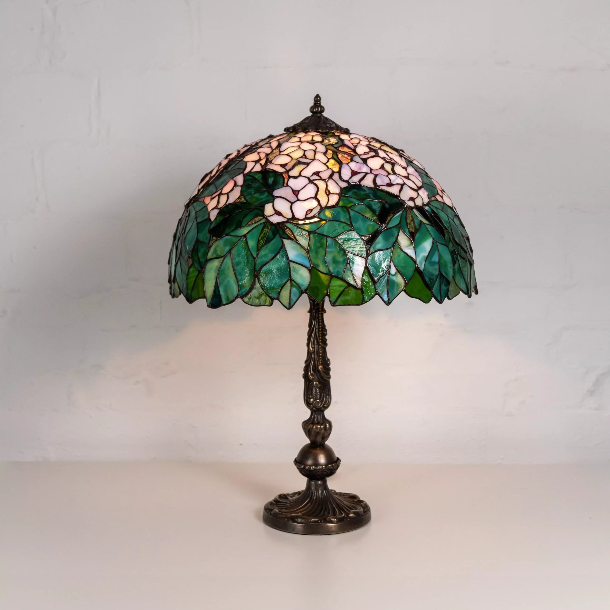 Tiffany-style stained glass chestnut lamp with pink flower and green leaf pattern on white background