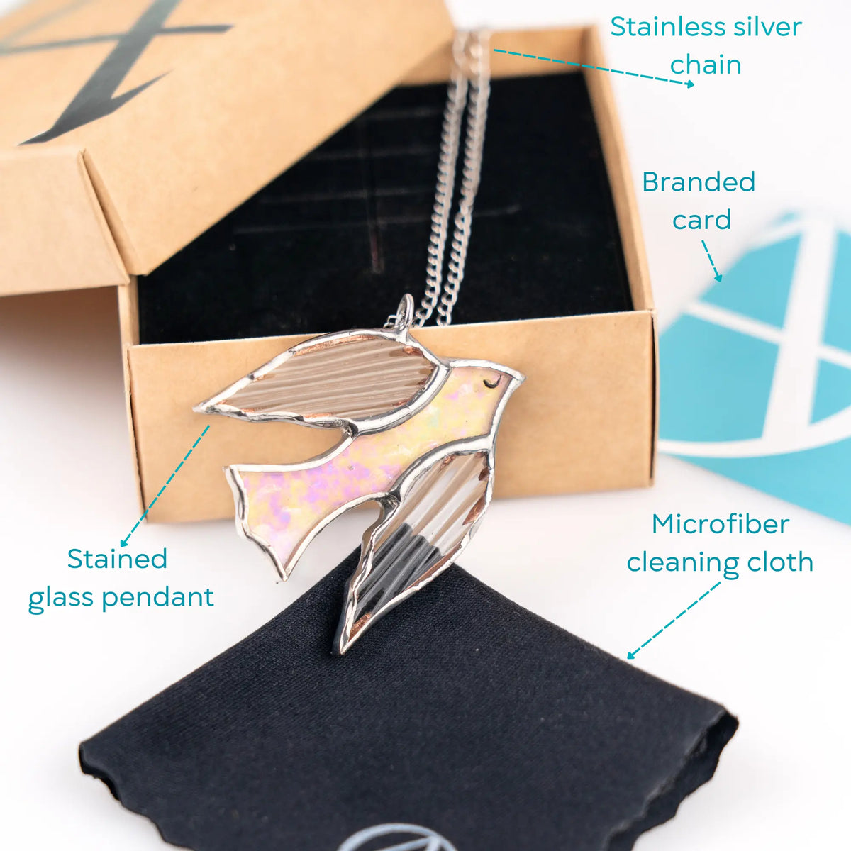 Necklace with stained glass pendant in an open box, featuring labeled components.