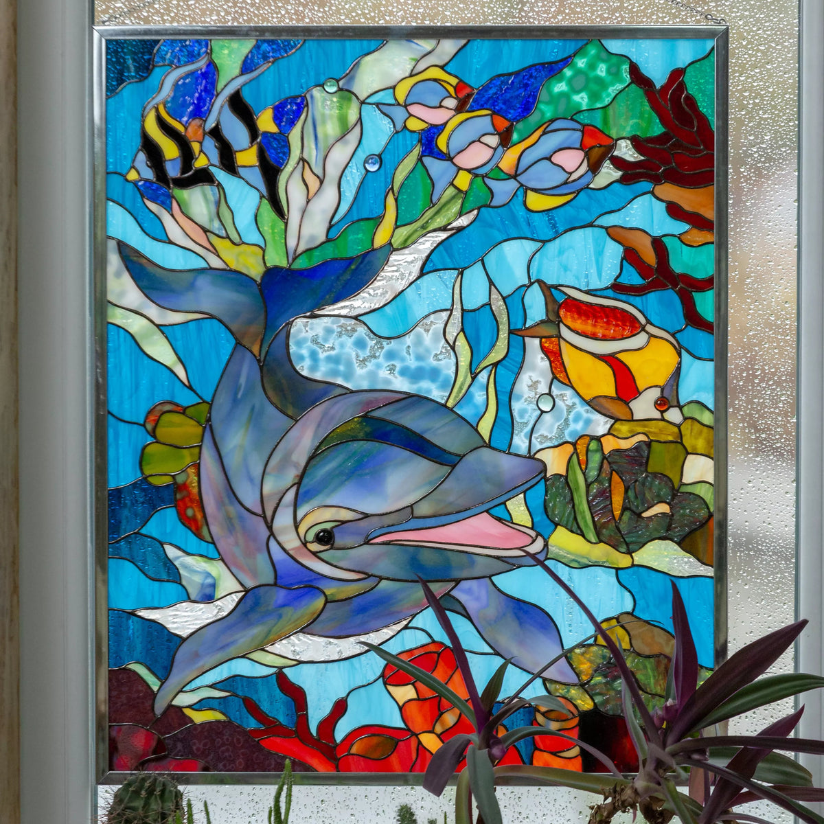 Custom stained glass panel with dolphin and fish in an underwater scene