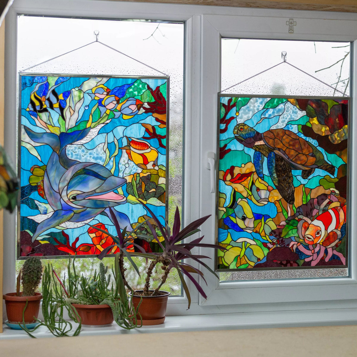 Custom stained glass panels with ocean underwater scenes on a window