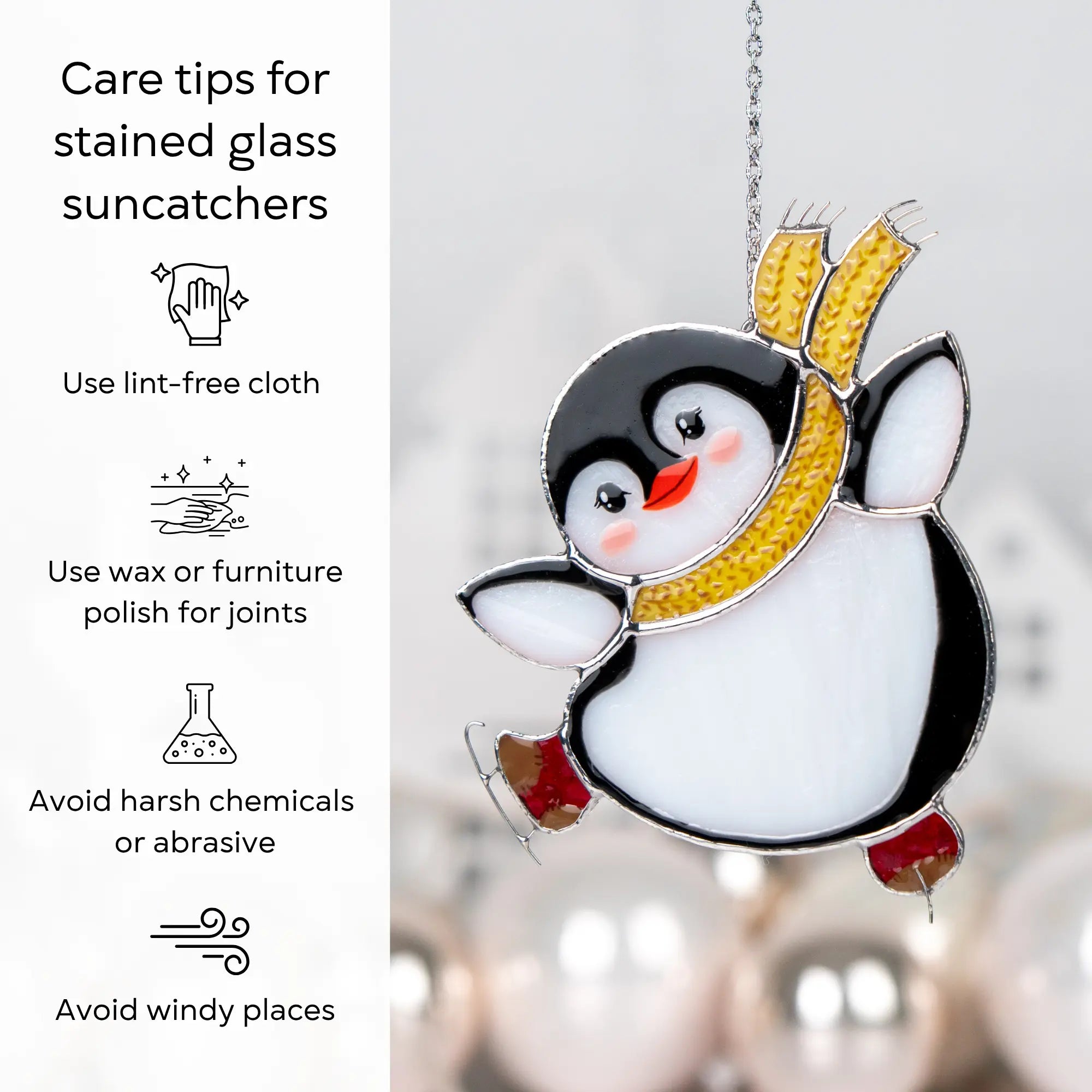 Stained glass penguin suncatcher with care tips on a blurred background: use lint-free cloth, polish joints with car wax or furniture polish, avoid harsh chemicals, and windy places.