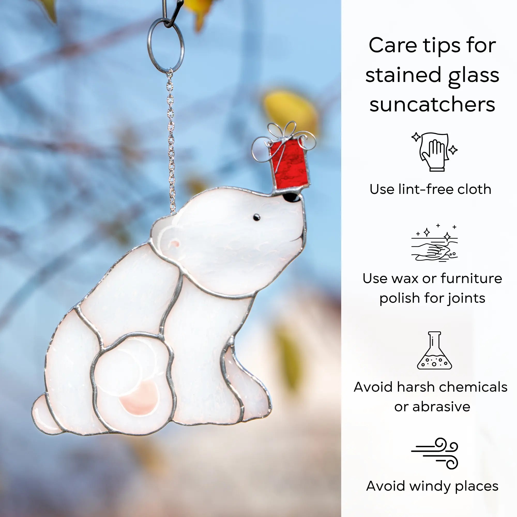 Stained glass polar bear window hanging with care tips on a blurred natural background: use lint-free cloth, polish joints with car wax or furniture polish, avoid harsh chemicals, and windy places.