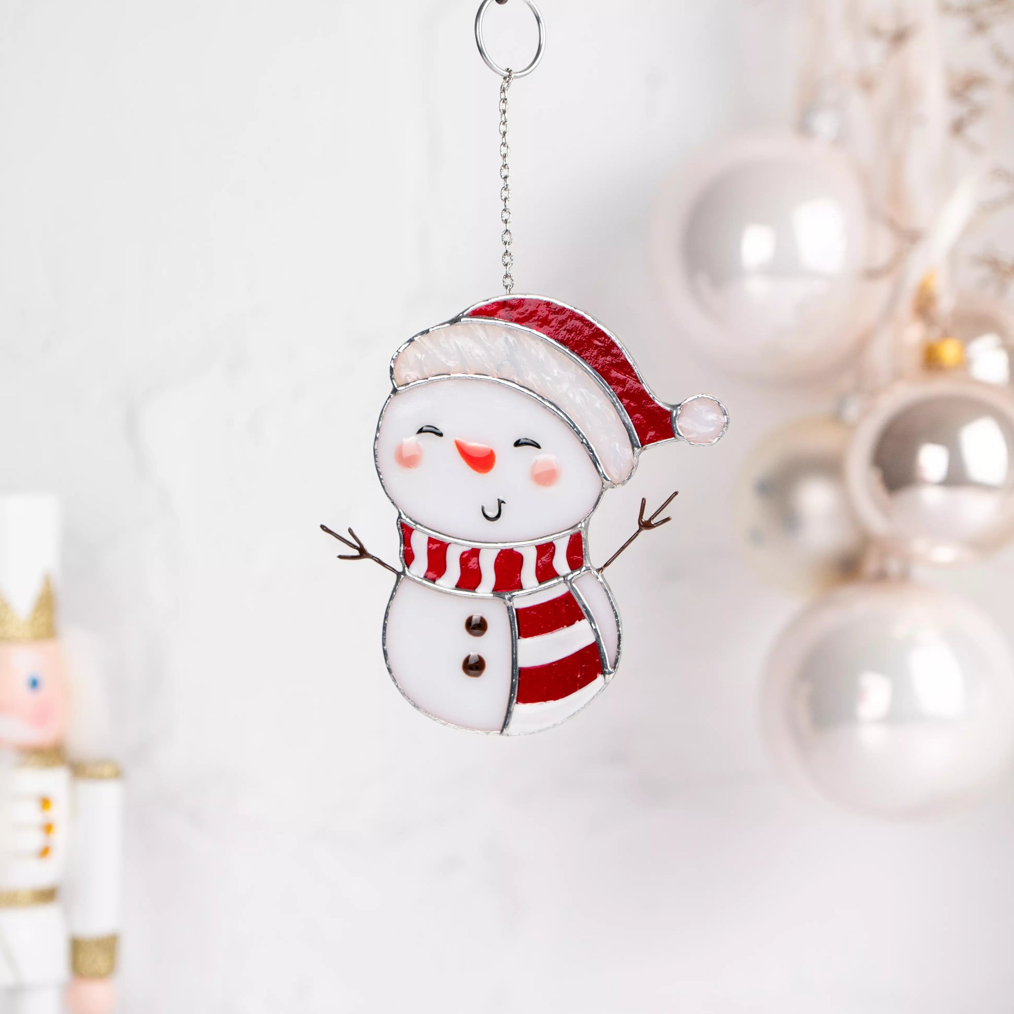 Stained glass suncatcher snowman with a red hat and scarf on a white background