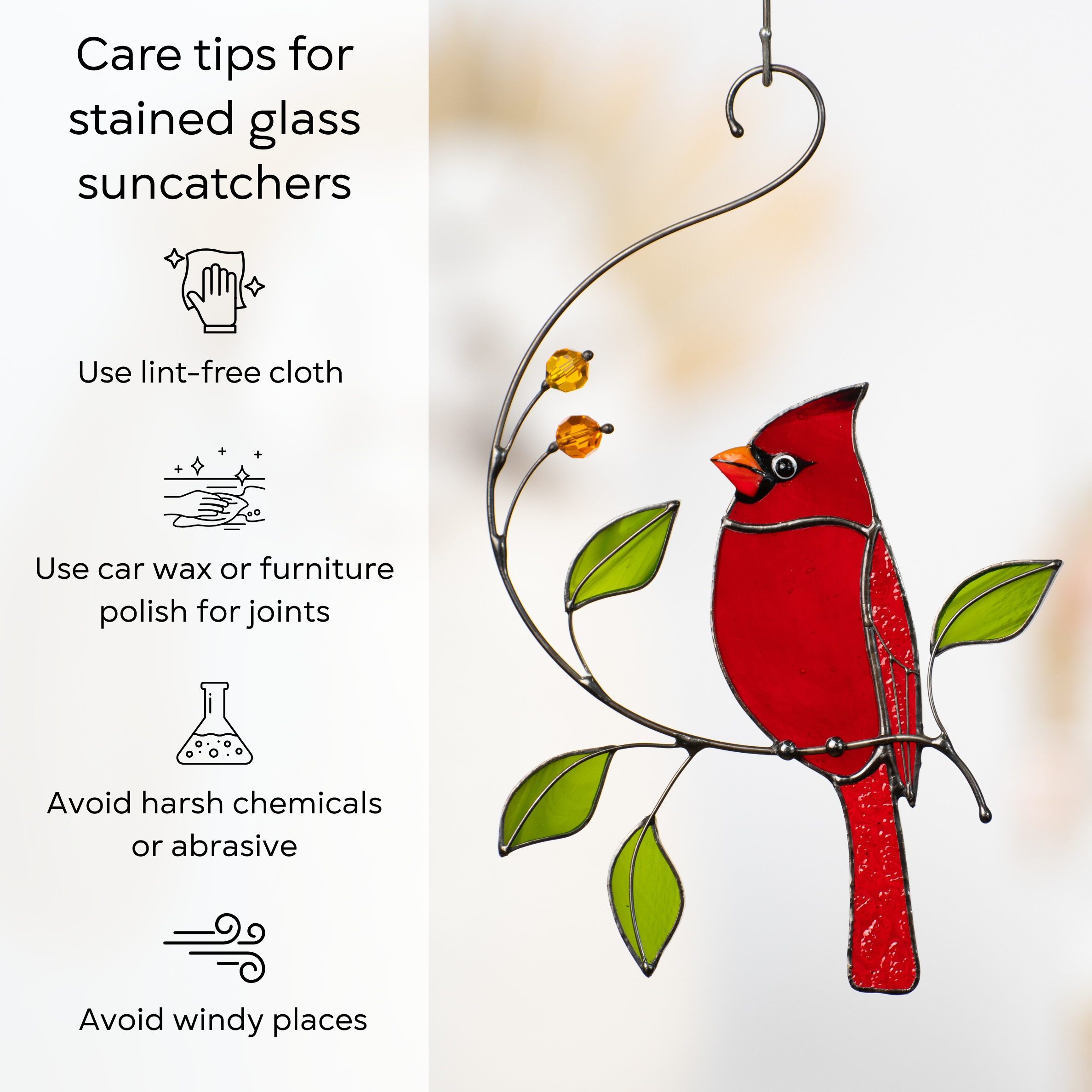 Red stained glass cardinal on leafy branch with care tips for cleaning and maintaining.