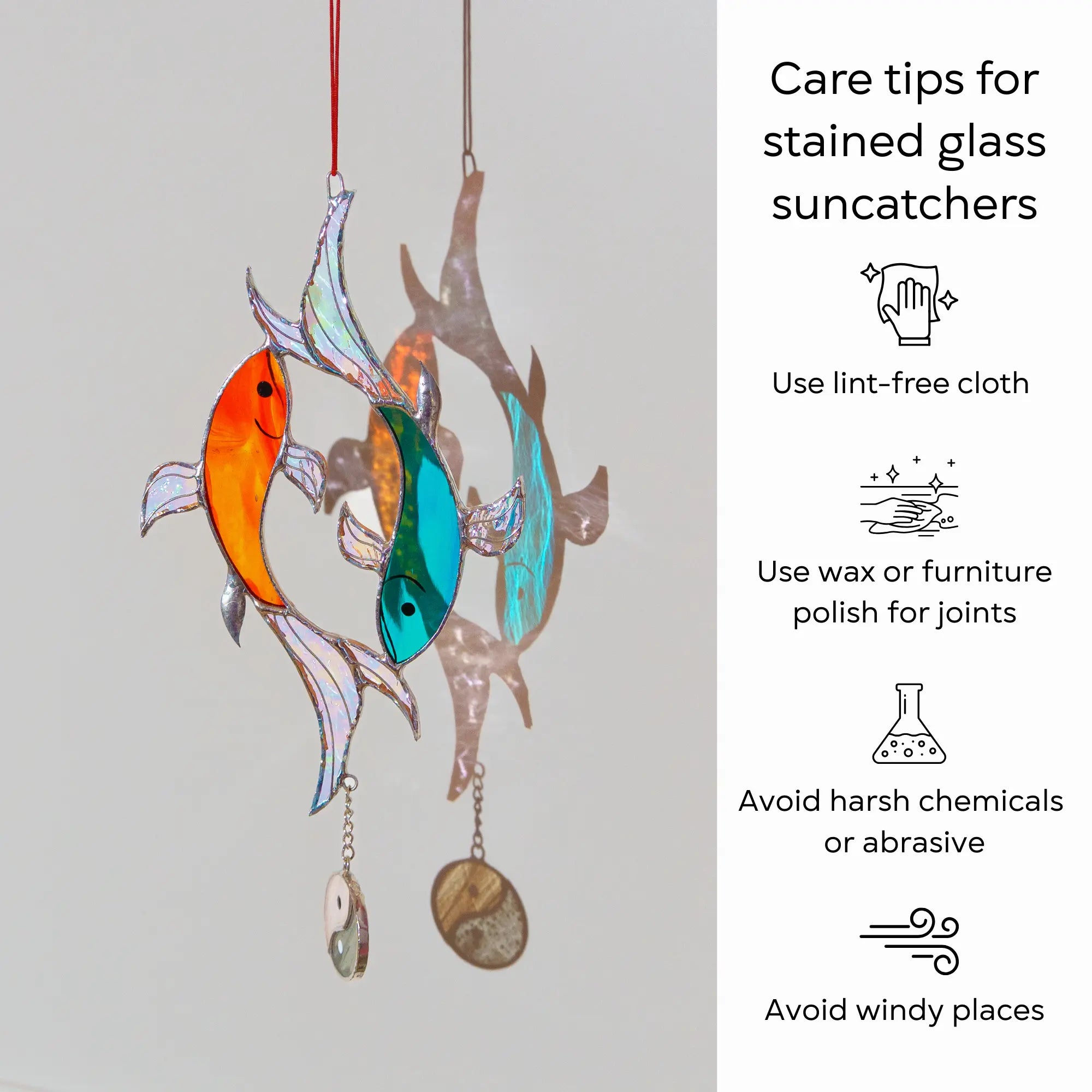 Stained glass yin-yang fish suncatcher with care tips:n use lint-free cloth, polish joints with car wax or furniture polish, avoid harsh chemicals, and windy places.