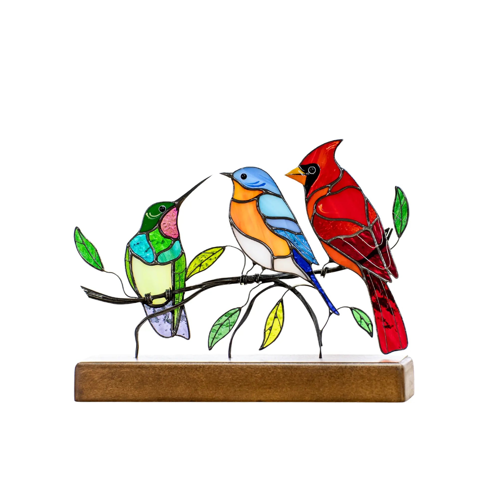 Colorful stained glass hummingbird, bluebird, and cardinal sitting on a leafy branch with wood base