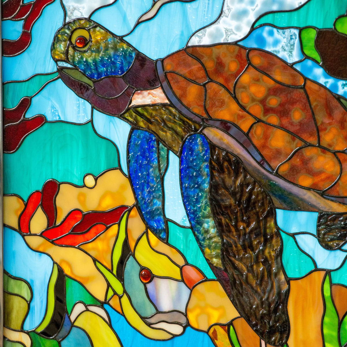 Custom stained glass panel featuring turtle with colorful fishes and blue background
