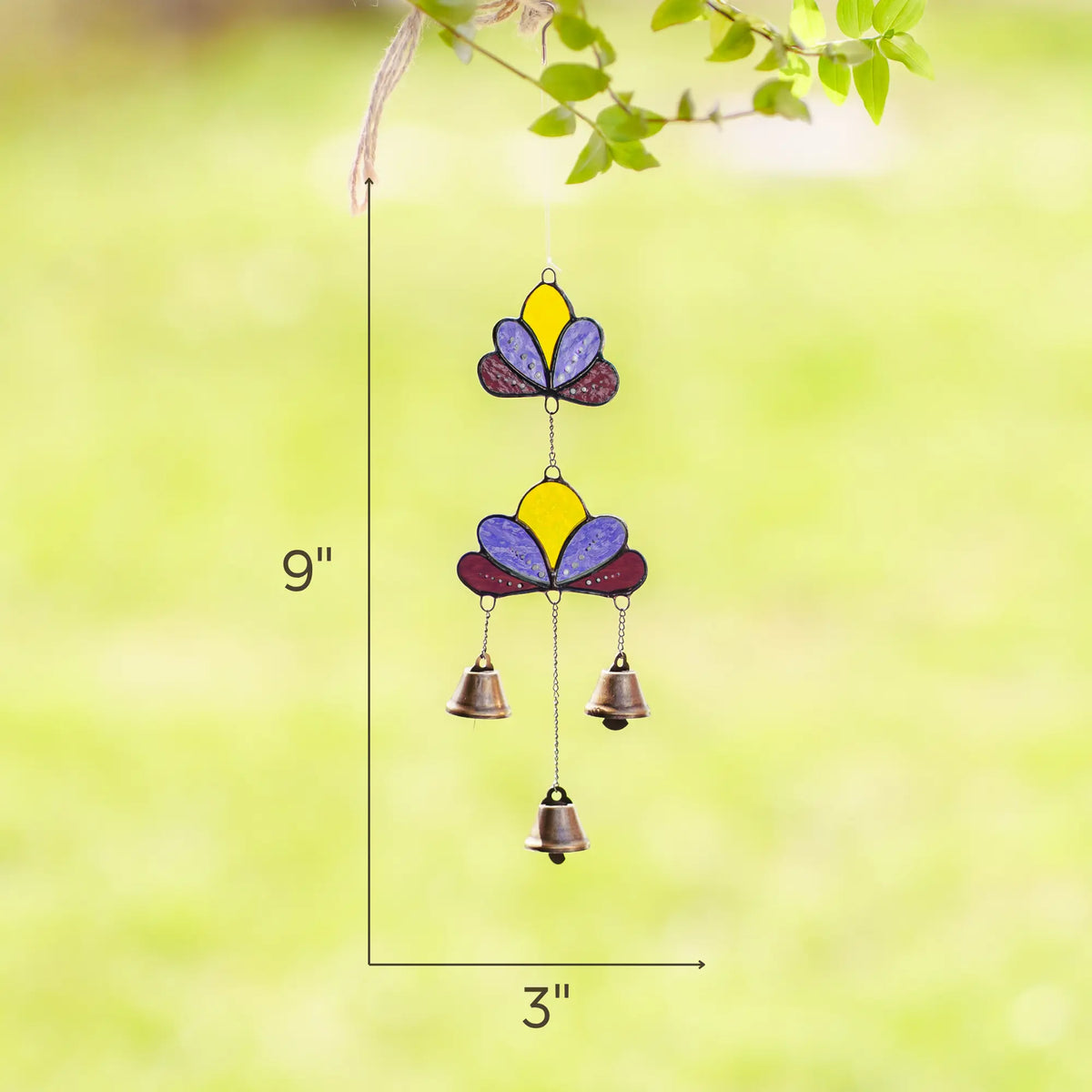Lotus-themed stained glass wind chime measuring 9 inches tall and 3 inches wide, displayed against a blurred green background.