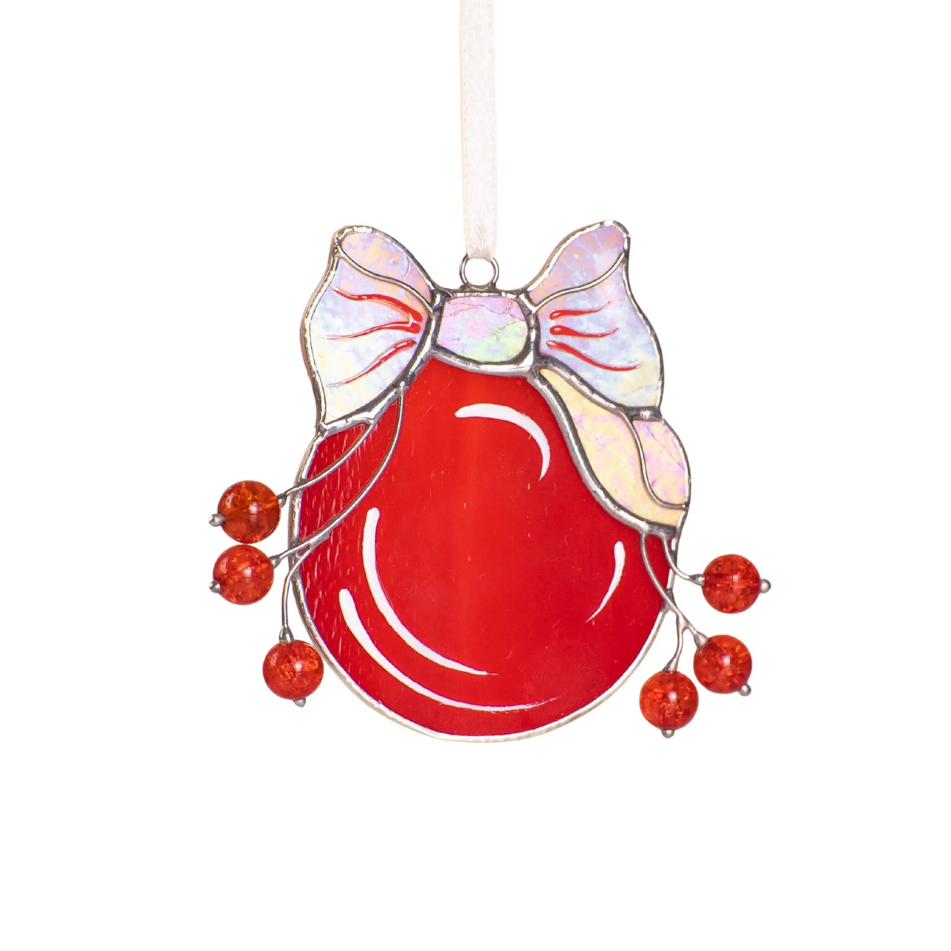 Stained red glass ornament with iridescent bow on a white background