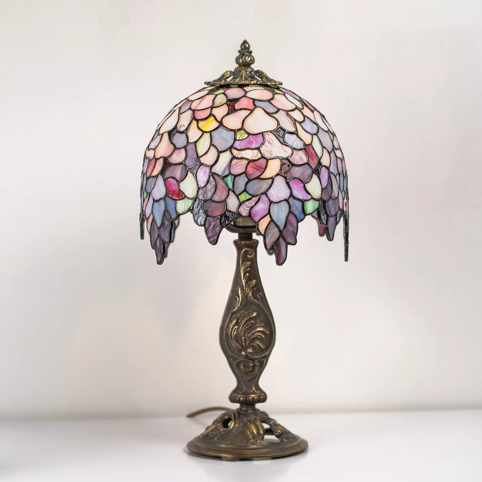 Tiffany table lamp Wisteria with a colorful glass shade on a white background