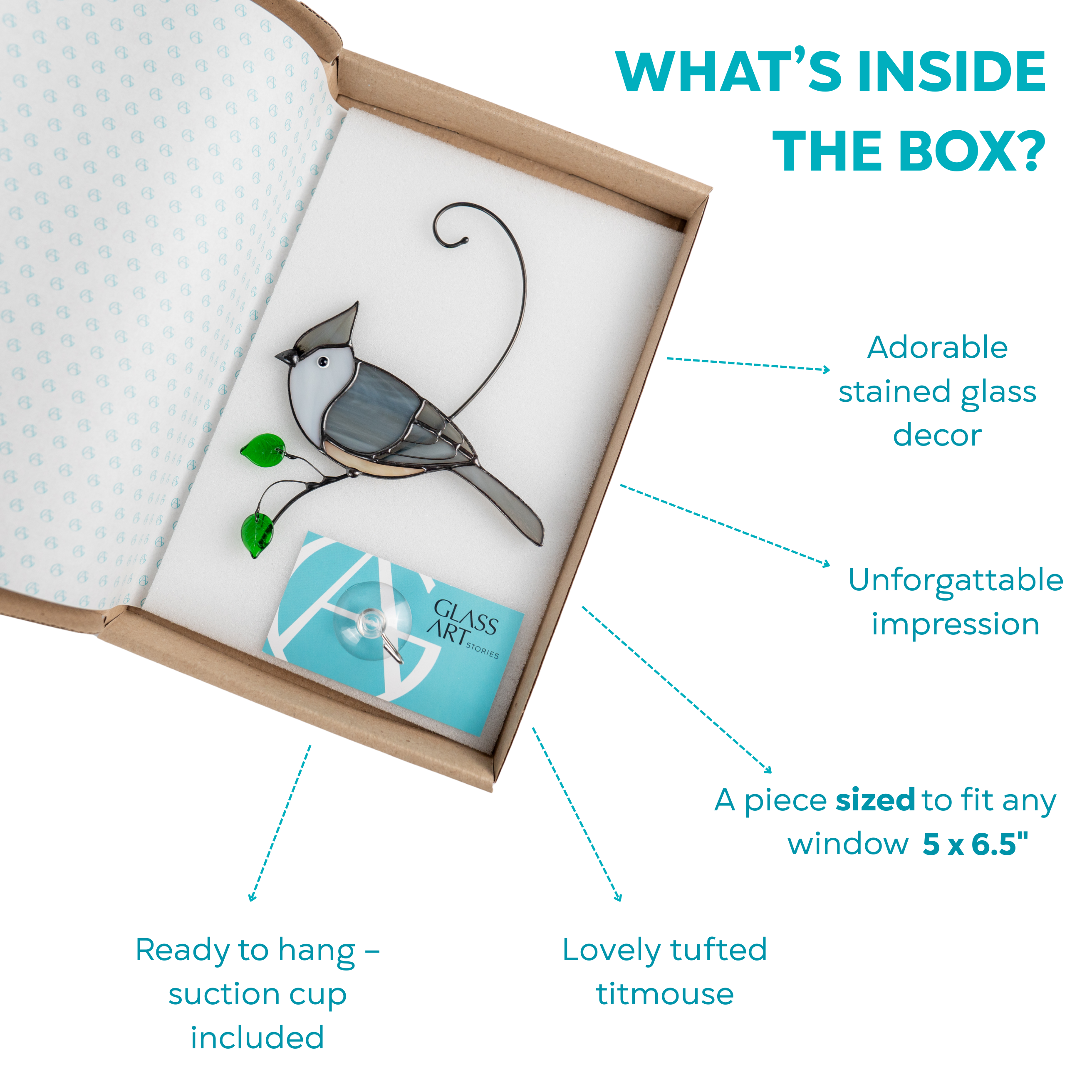 A boxed stained glass tufted titmouse with suction cup and green glass leaf, ready for gifting.
