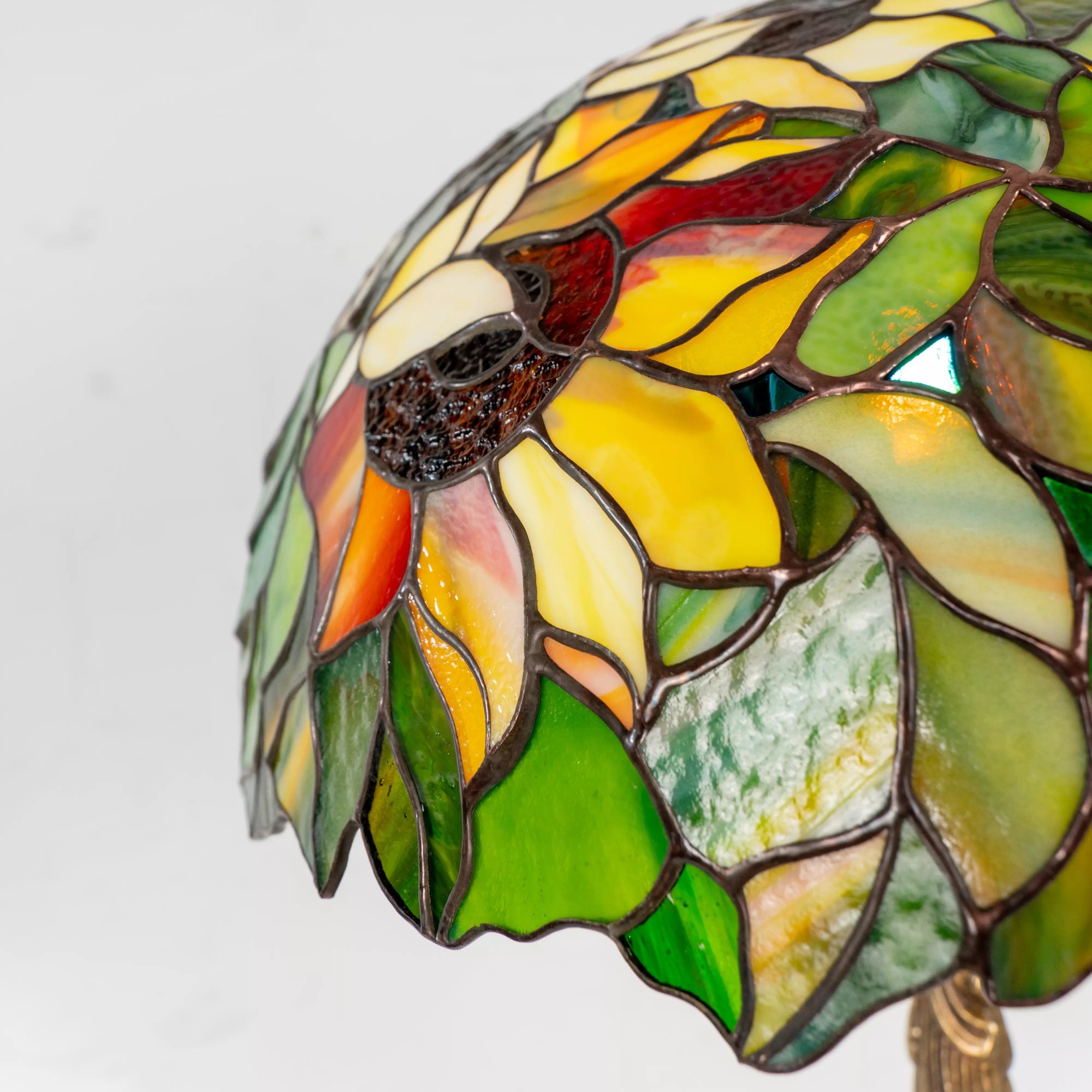 Macro of stained glass sunflower petal textures and copper foil lines