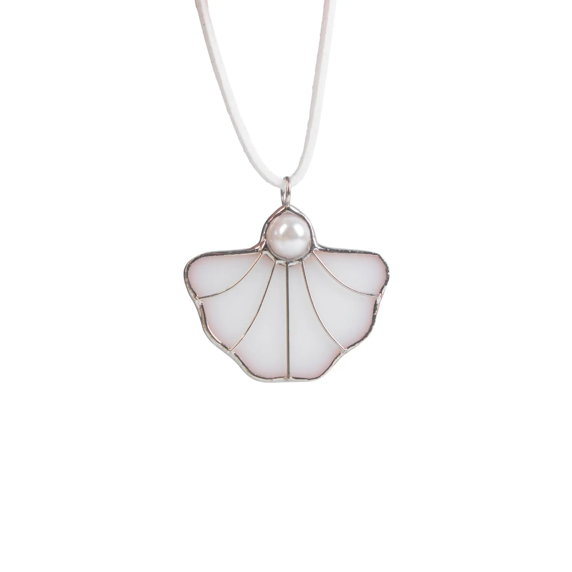 Close-up of a white stained glass shell pendant with a pearl detail hanging on a white vegan suede cord.