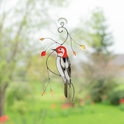 Stained glass window hanging of a woodpecker