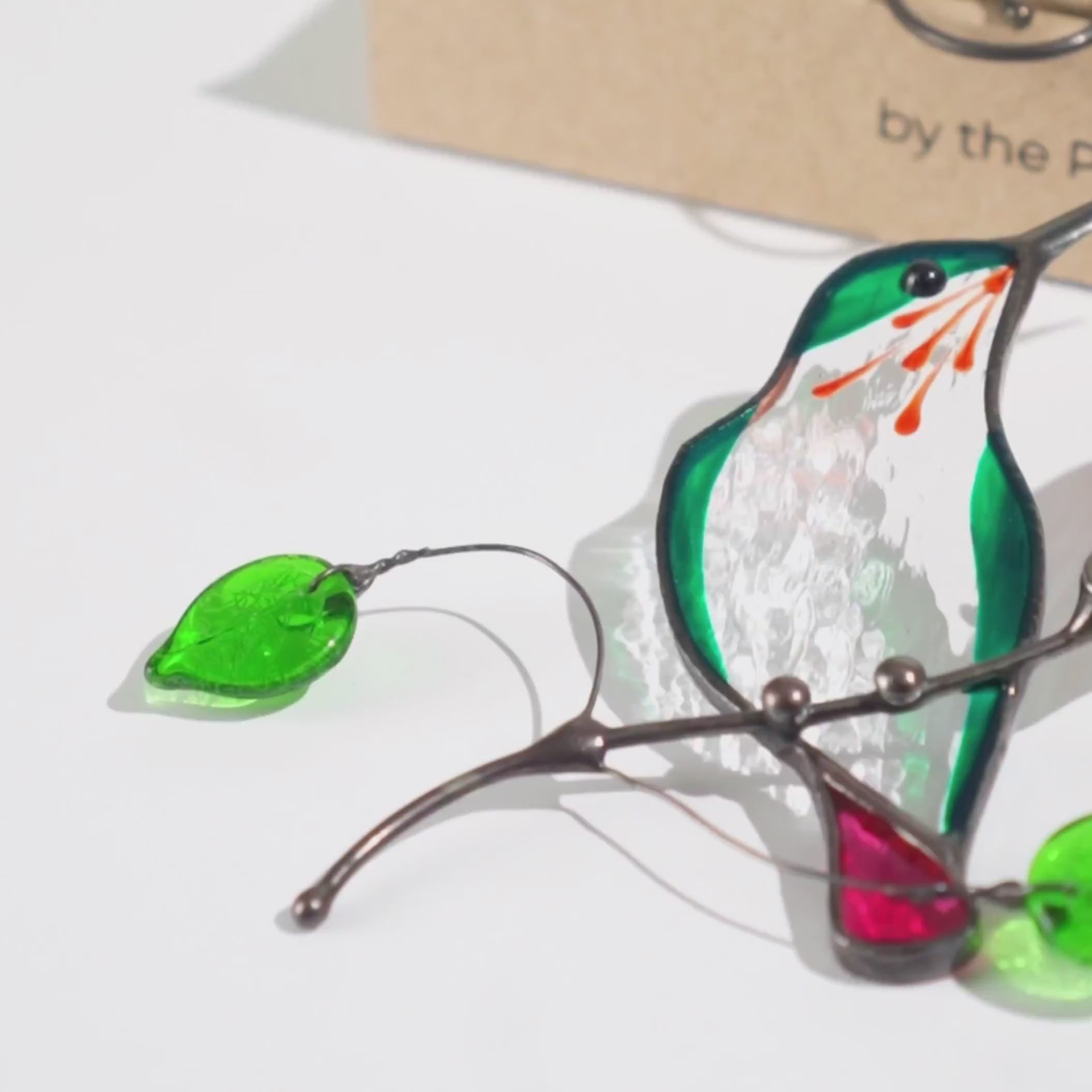 Stained glass green hummingbird suncatcher with green glass leaves