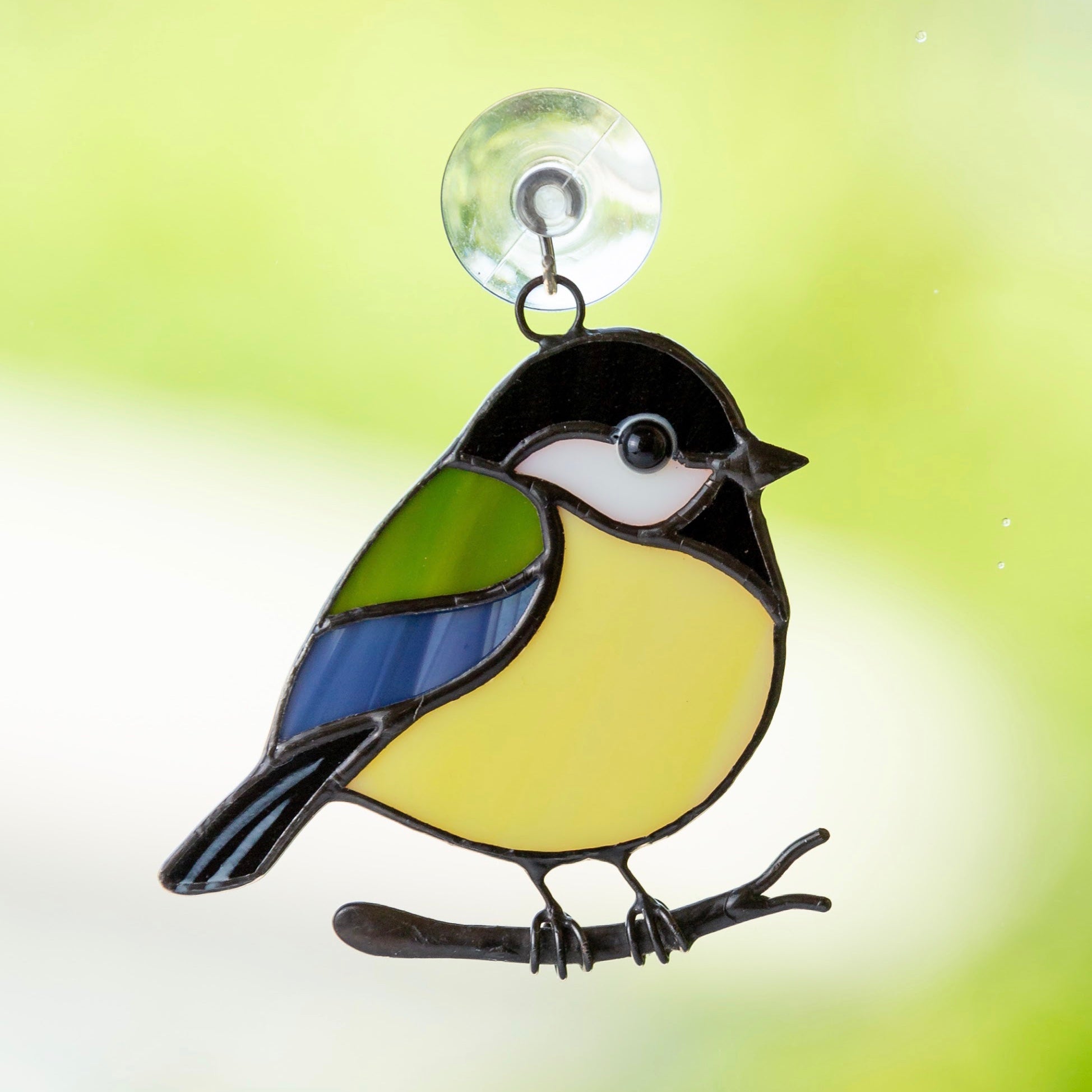 Sitting on the branch chickadee of stained glass