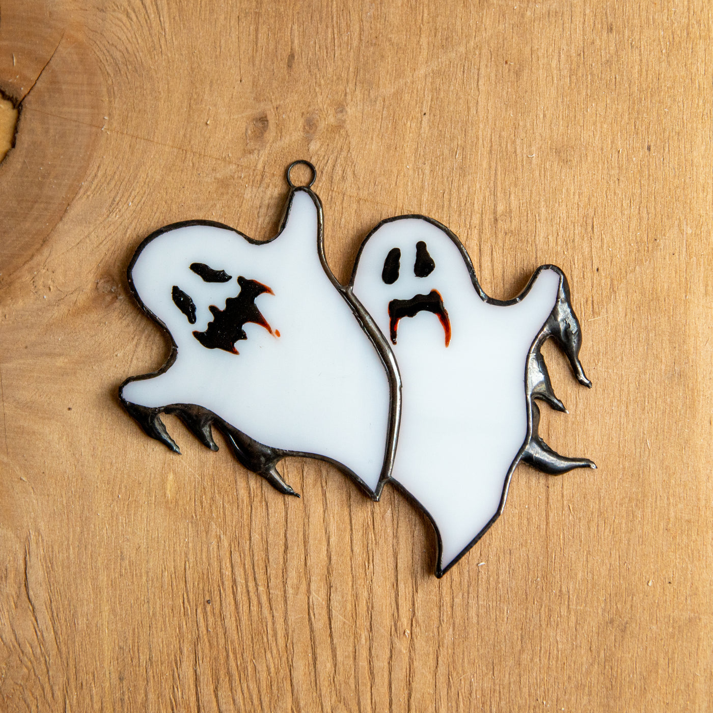 Stained glass suncatcher of ghastly ghosts for Halloween