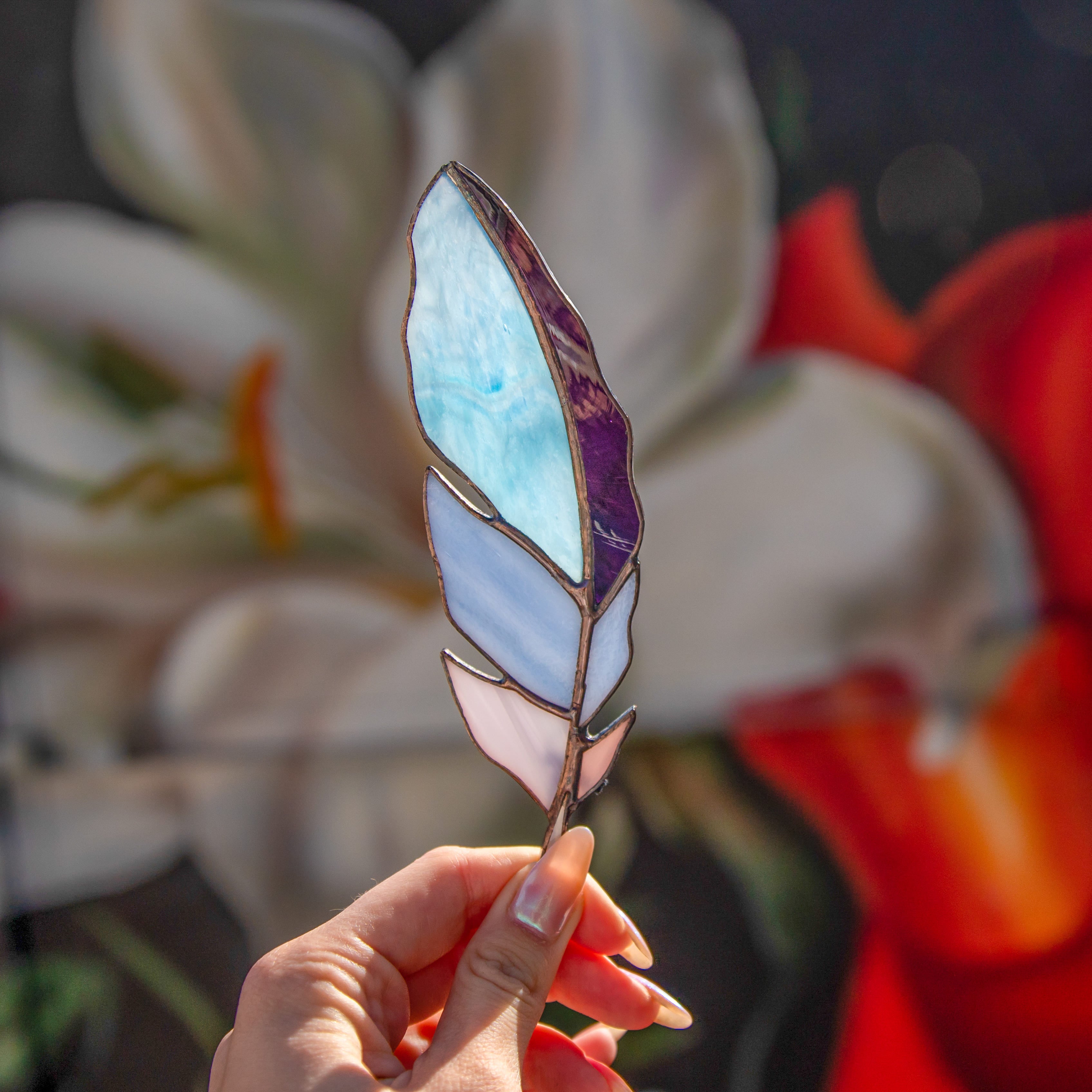 Blue and shades of purple stained glass feather window hanging