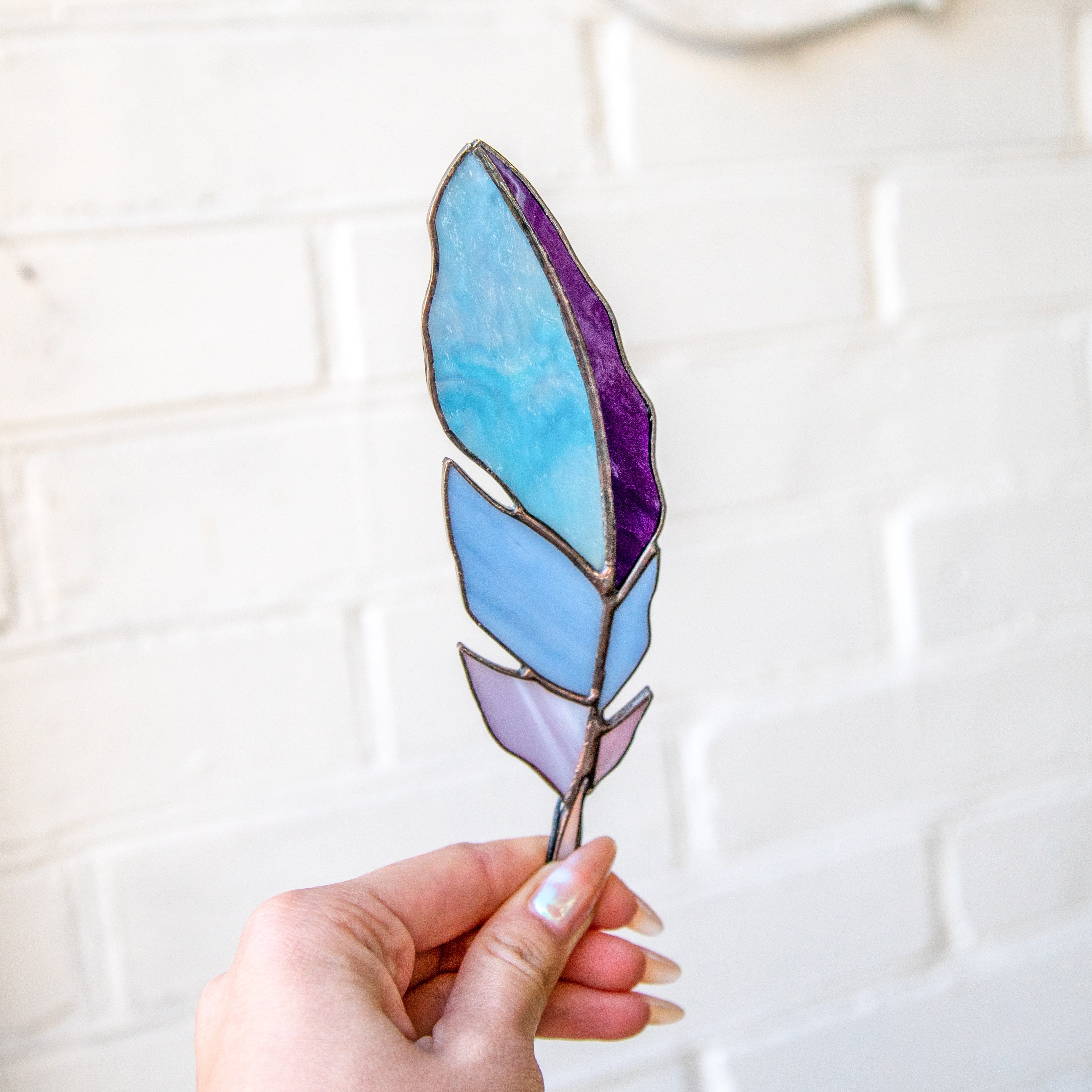 Stained glass blue feather with shades of purple suncatcher