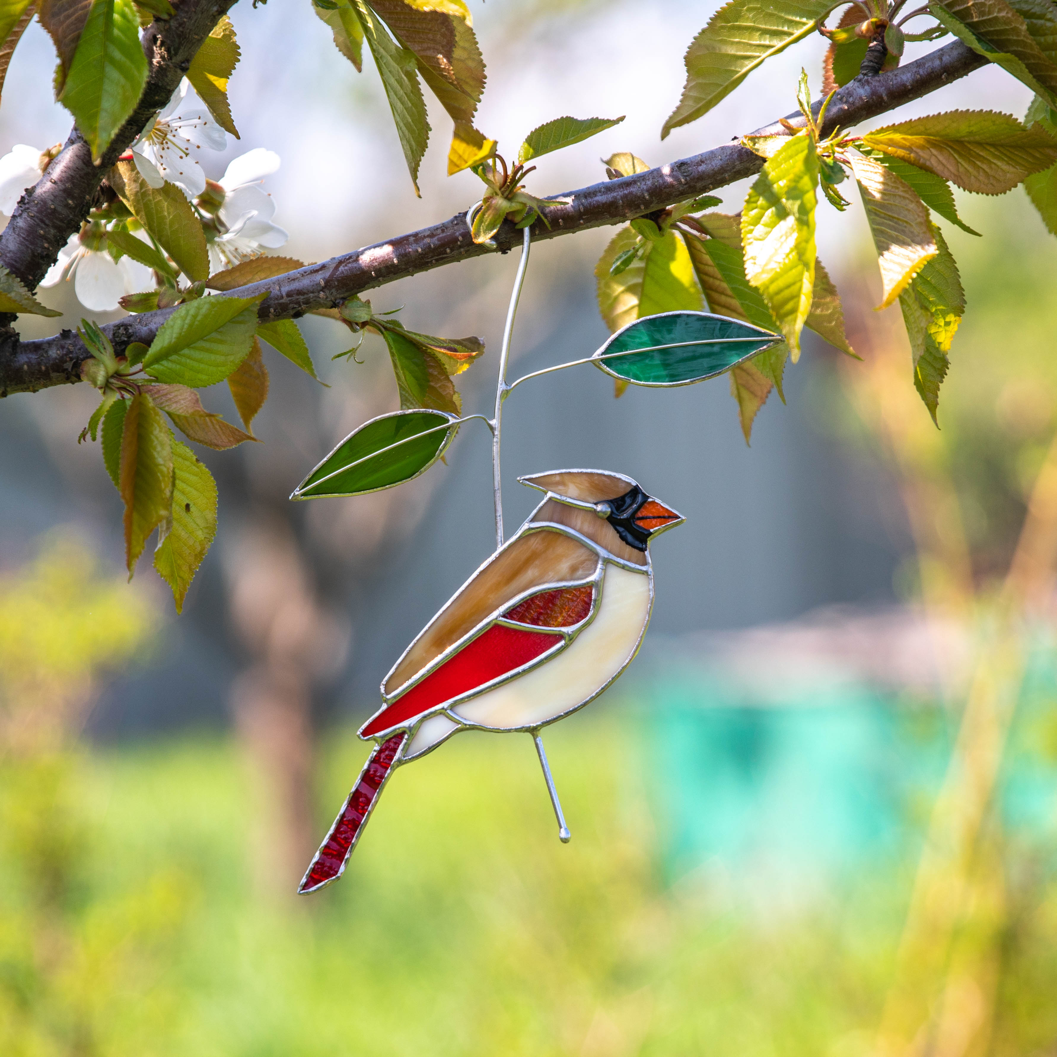 Stained glass female cardinal sitting on the branch window hanging