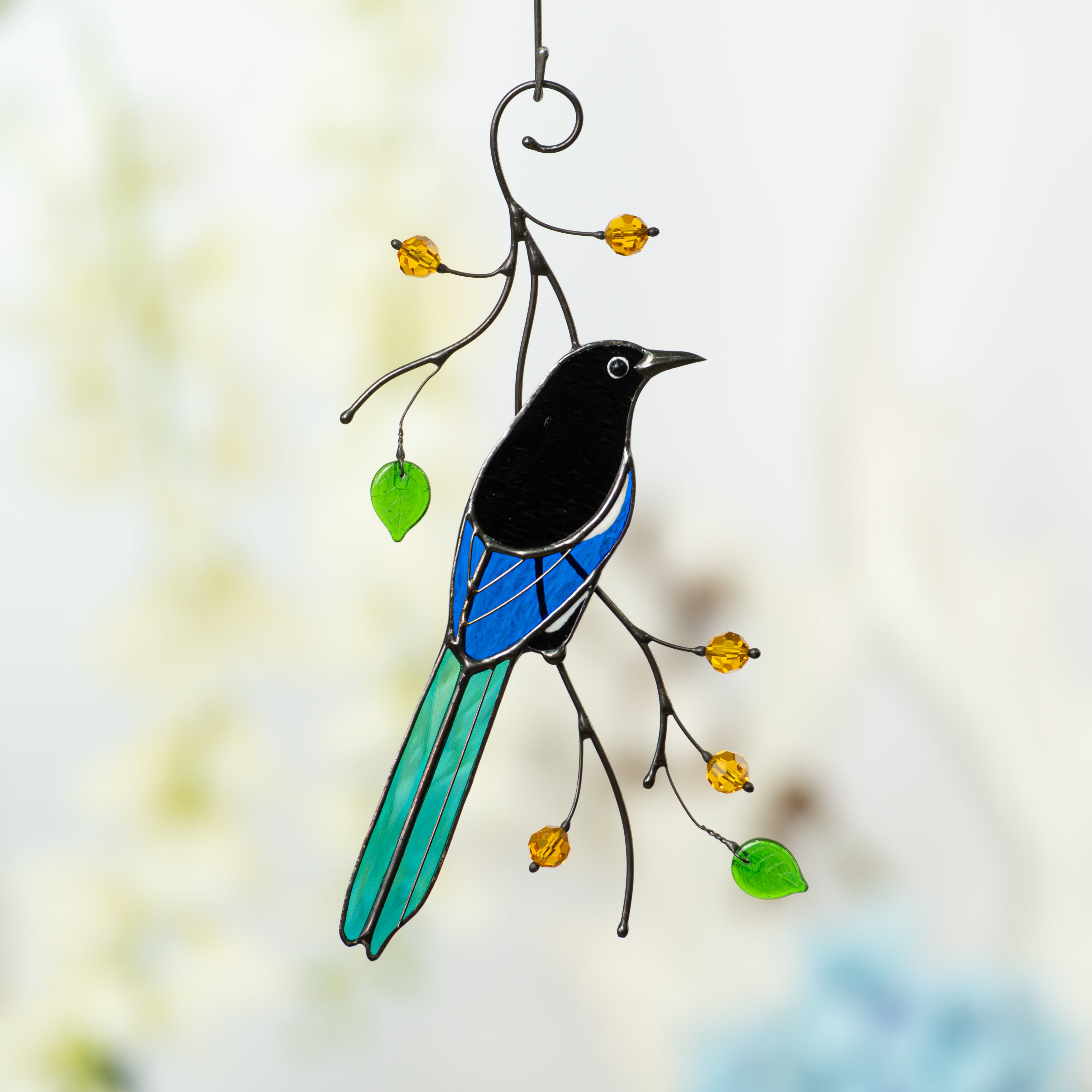 Stained glass back-view magpie on the branch with leaves and berries suncatcher