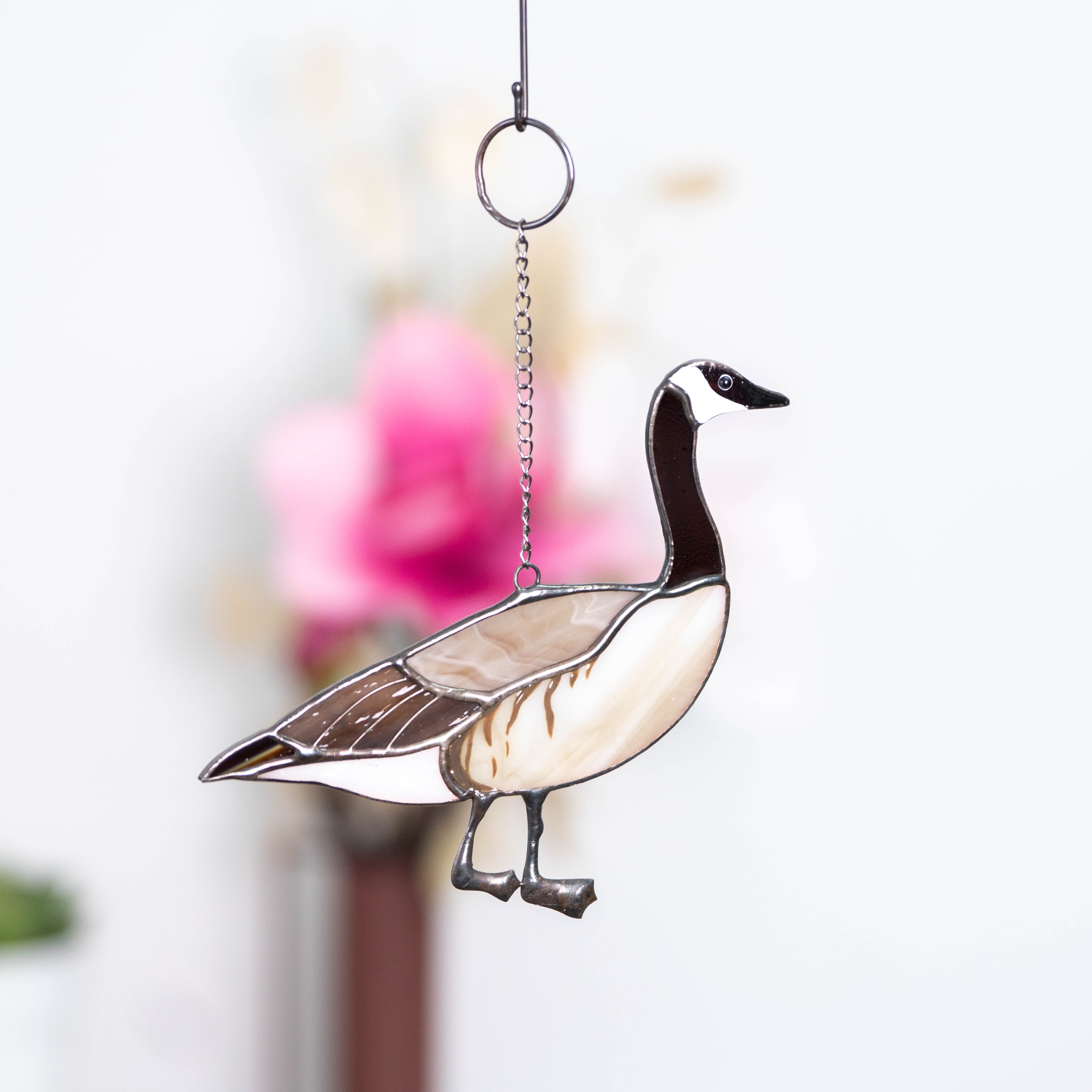 Stained glass window hanging of a Canadian goose looking right