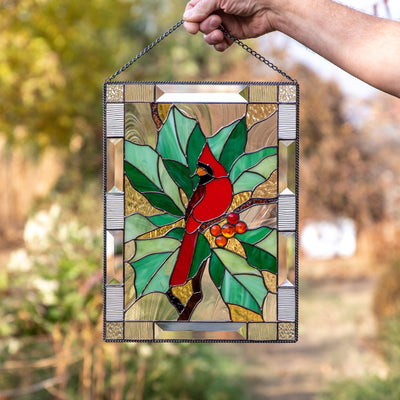 Stained glass panel of a cardinal on the branch with leaves and berries