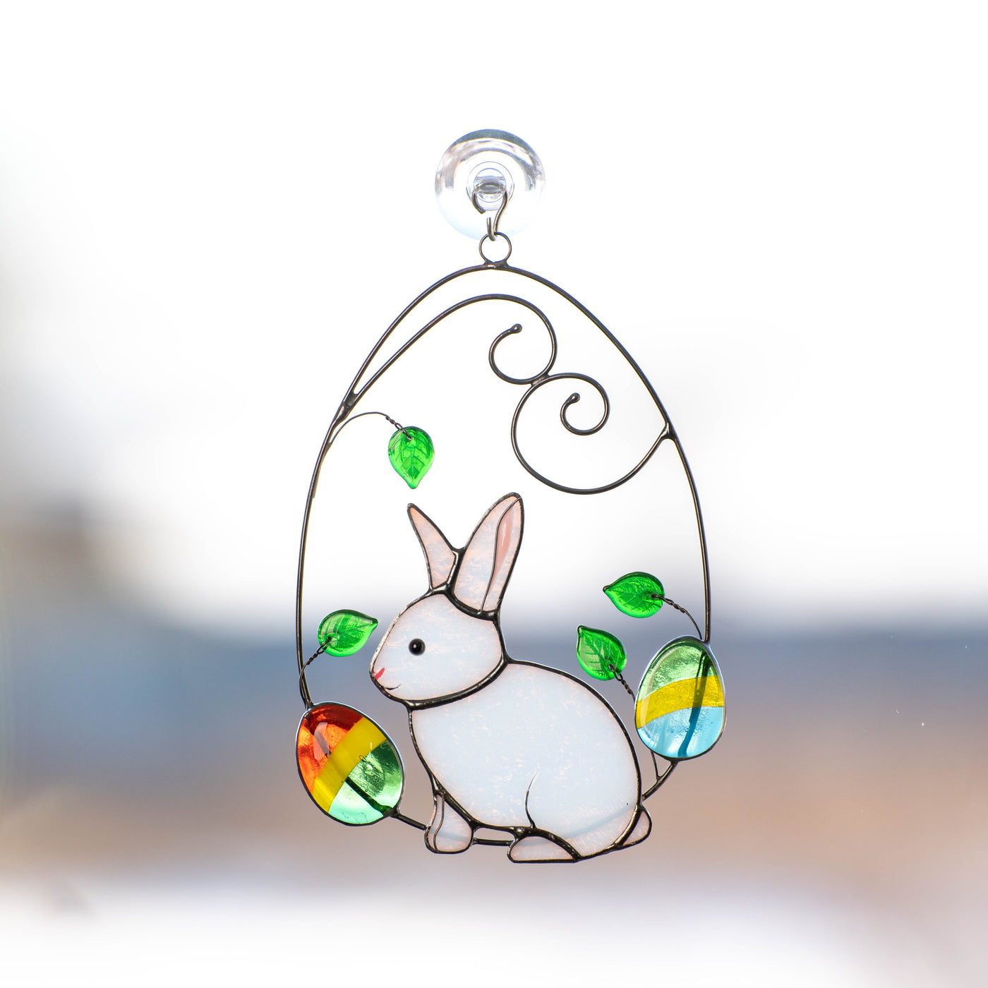 Stained glass bunny in a wired egg with two eggs on each side suncatcher for Easter decor