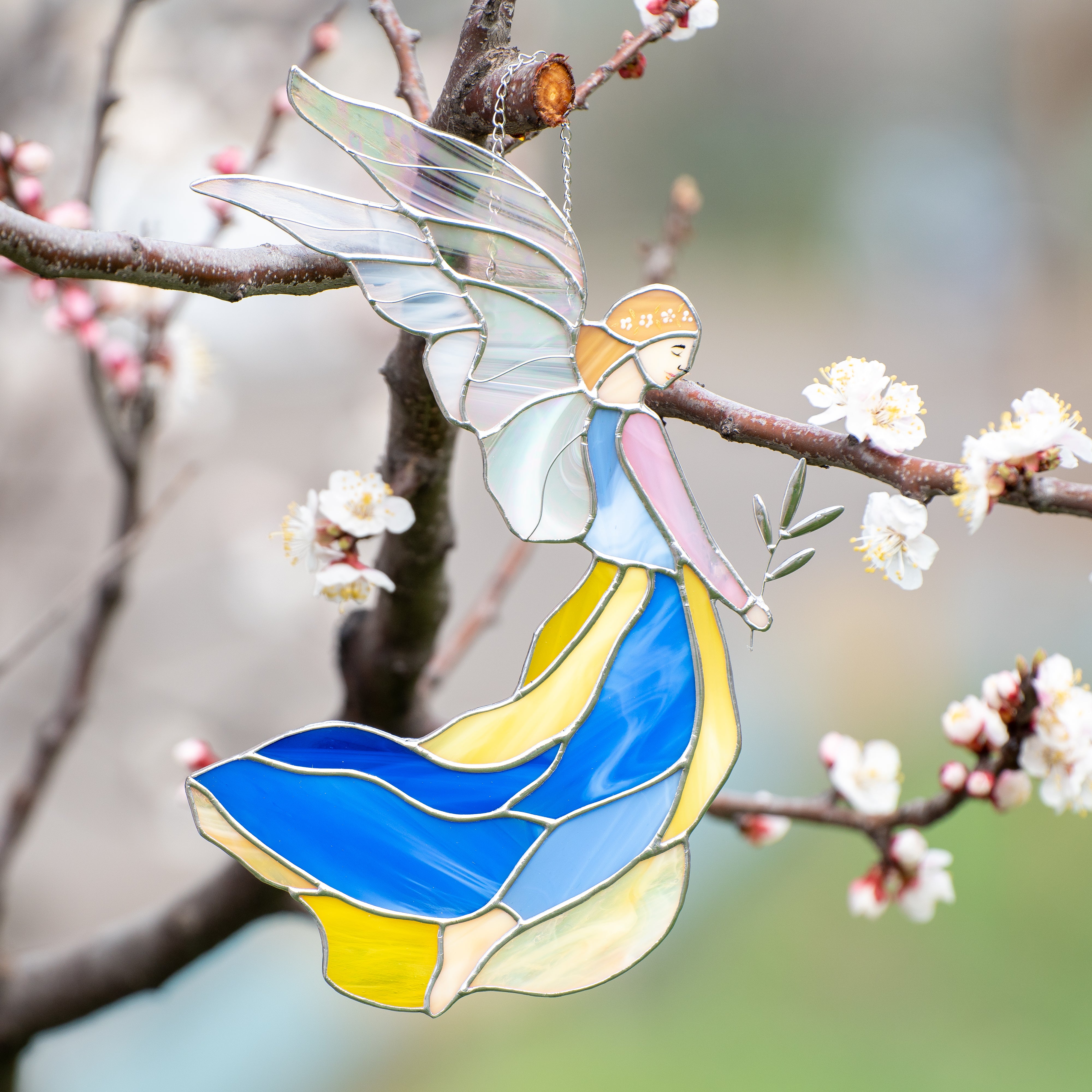 Stained glass girl guardian angel in blue and yellow dress with iridescent wings suncatcher