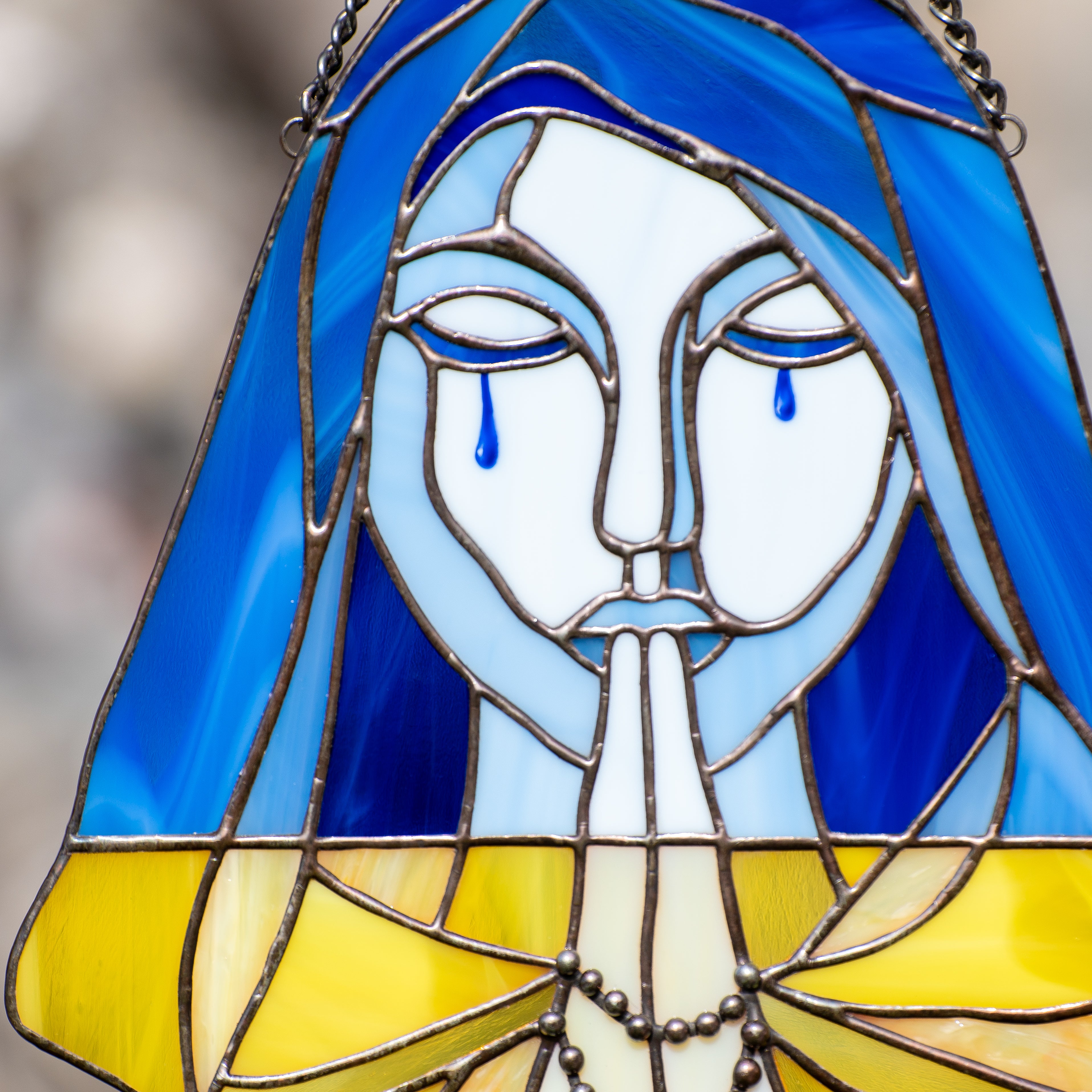 Zoomed stained glass crying Ukraine