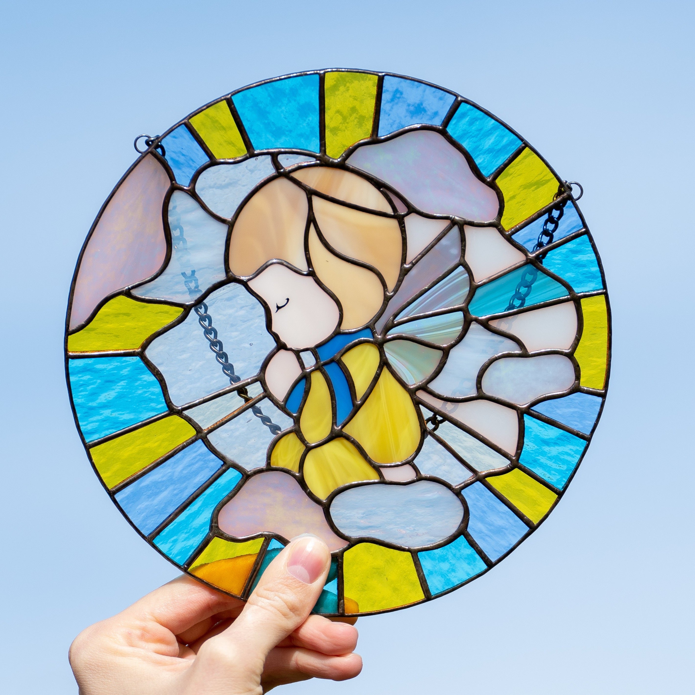 Zoomed stained glass window panel depicting angel