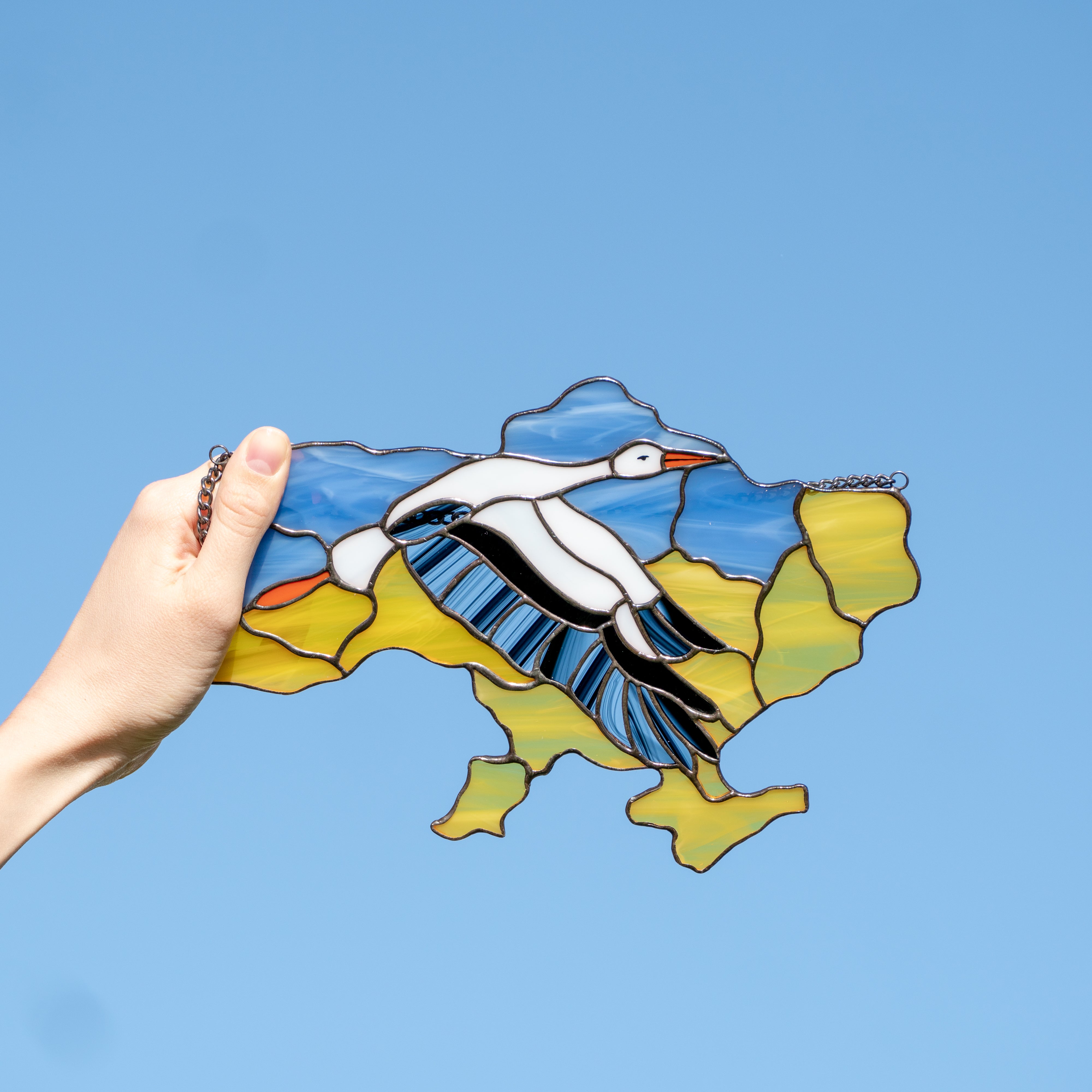 Stained glass Ukrainian map with the flying stork in the middle window hanging