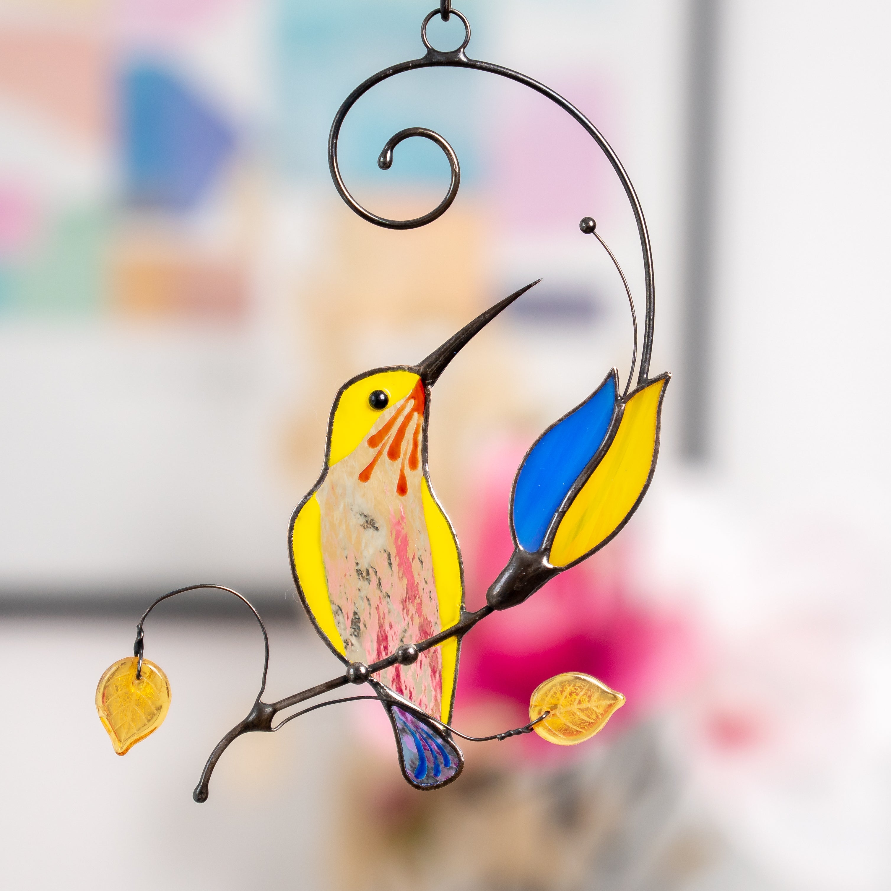 Stained glass yellow hummingbird with blue and yellow flower suncatcher