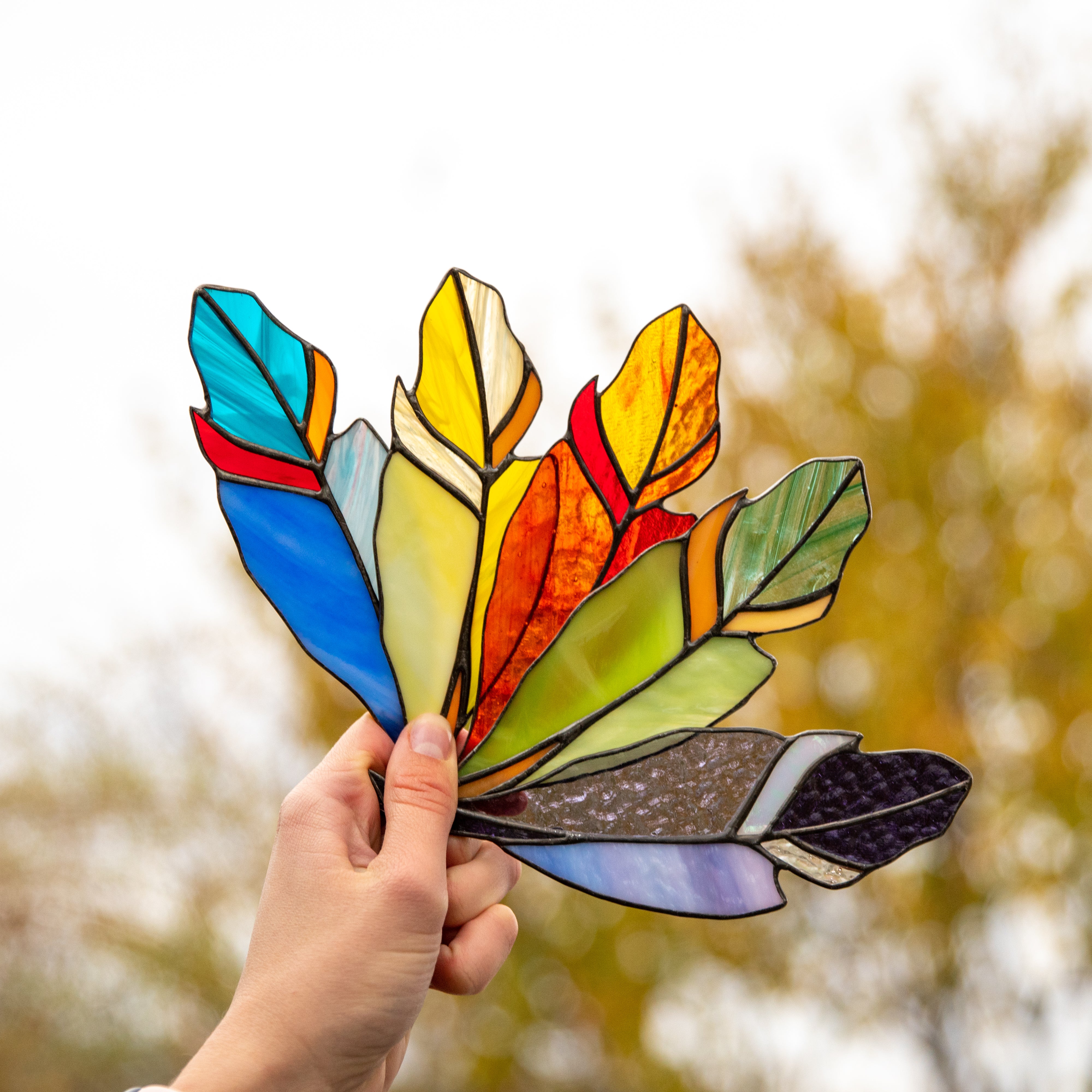 The collection of 5 stained glass feather suncatchers