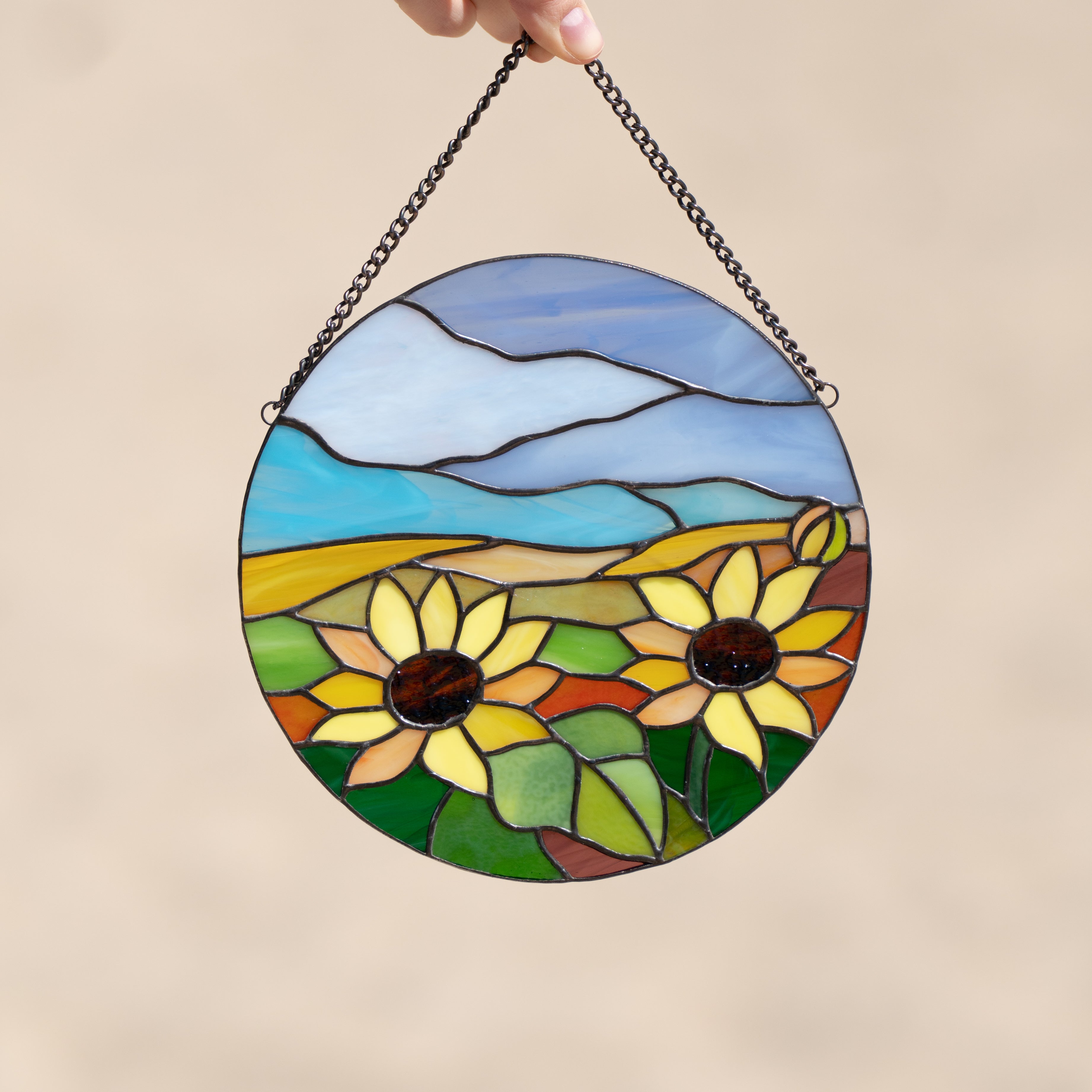 Zoomed panel depicting sunflowers and blue skies of stained glass
