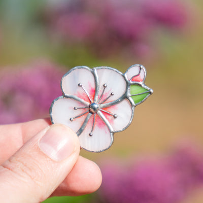 Stained glass sakura blossom flower with a green leaf brooch