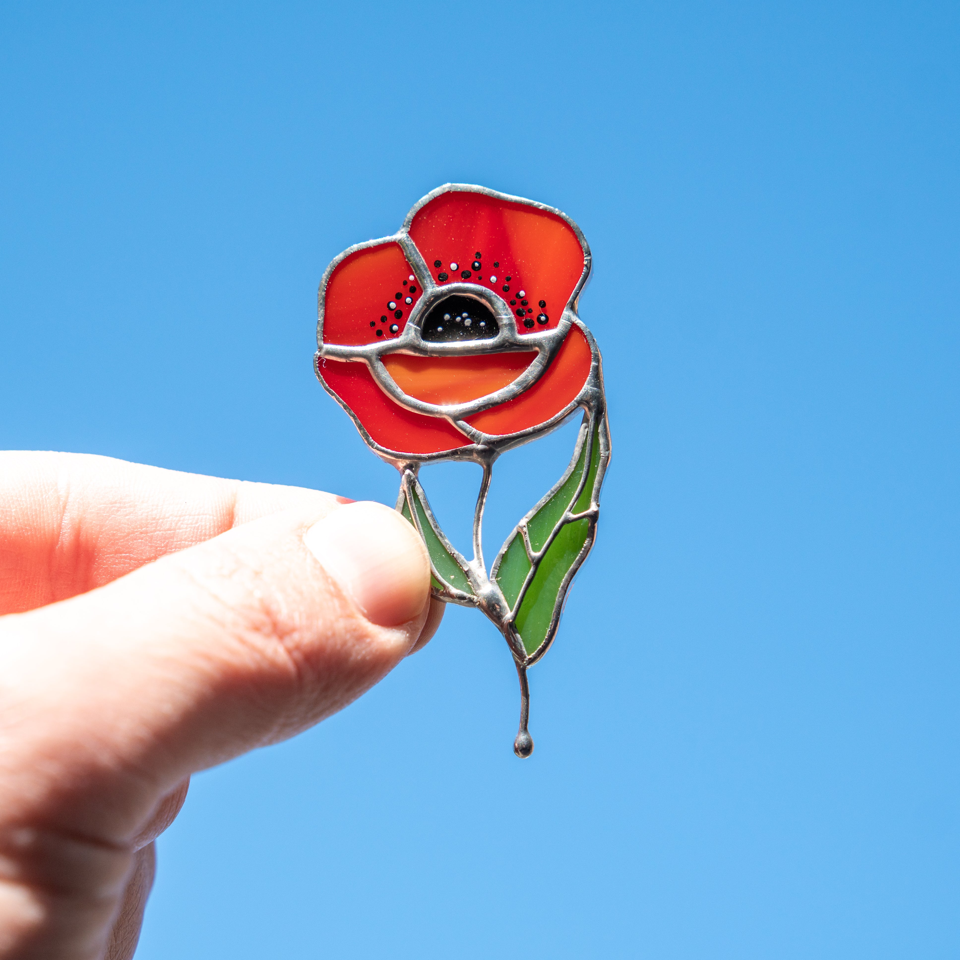 Stained glass handmade brooch of a red poppy